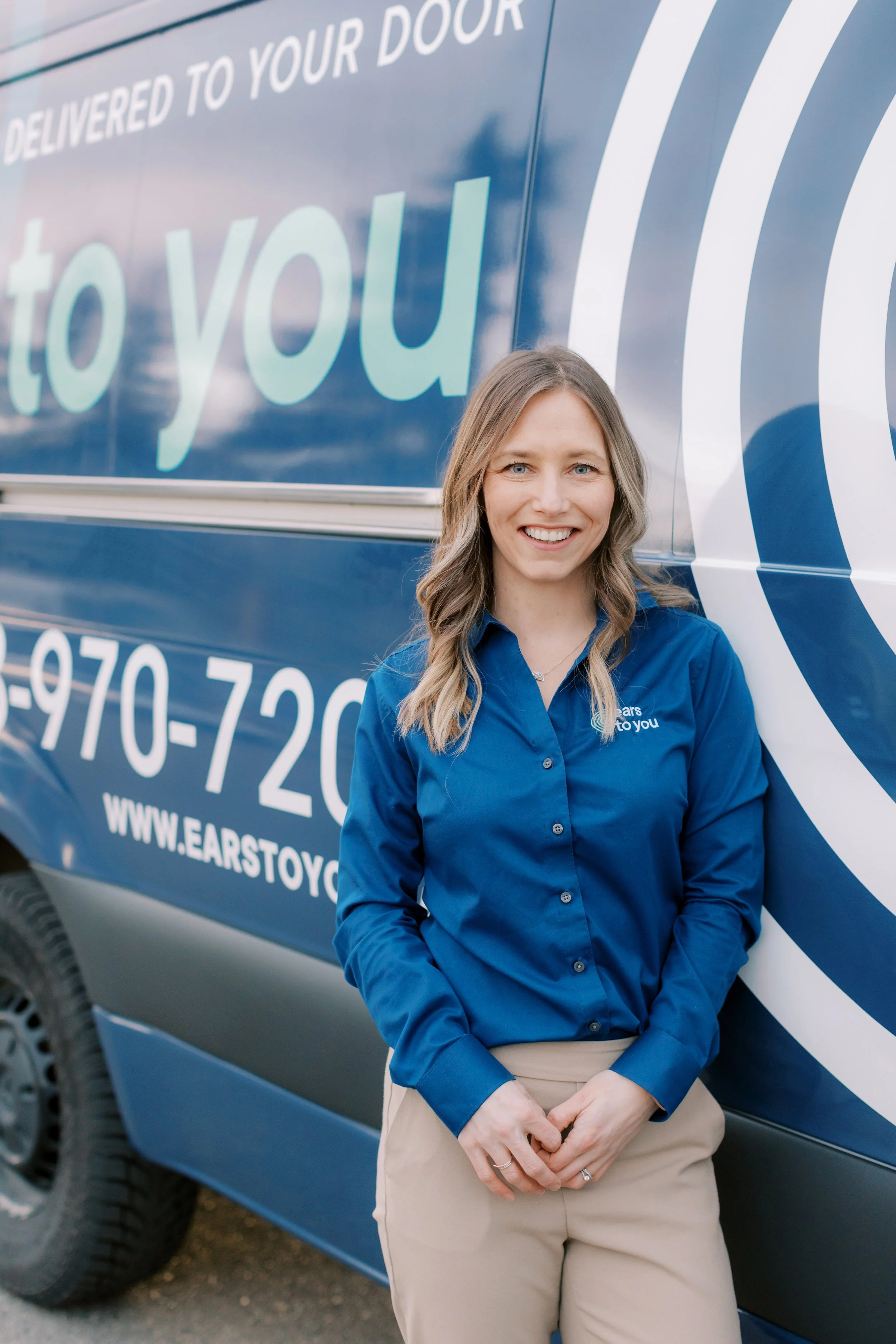 Trish Ehman, Owner of Ears To You, smiling into the camera.