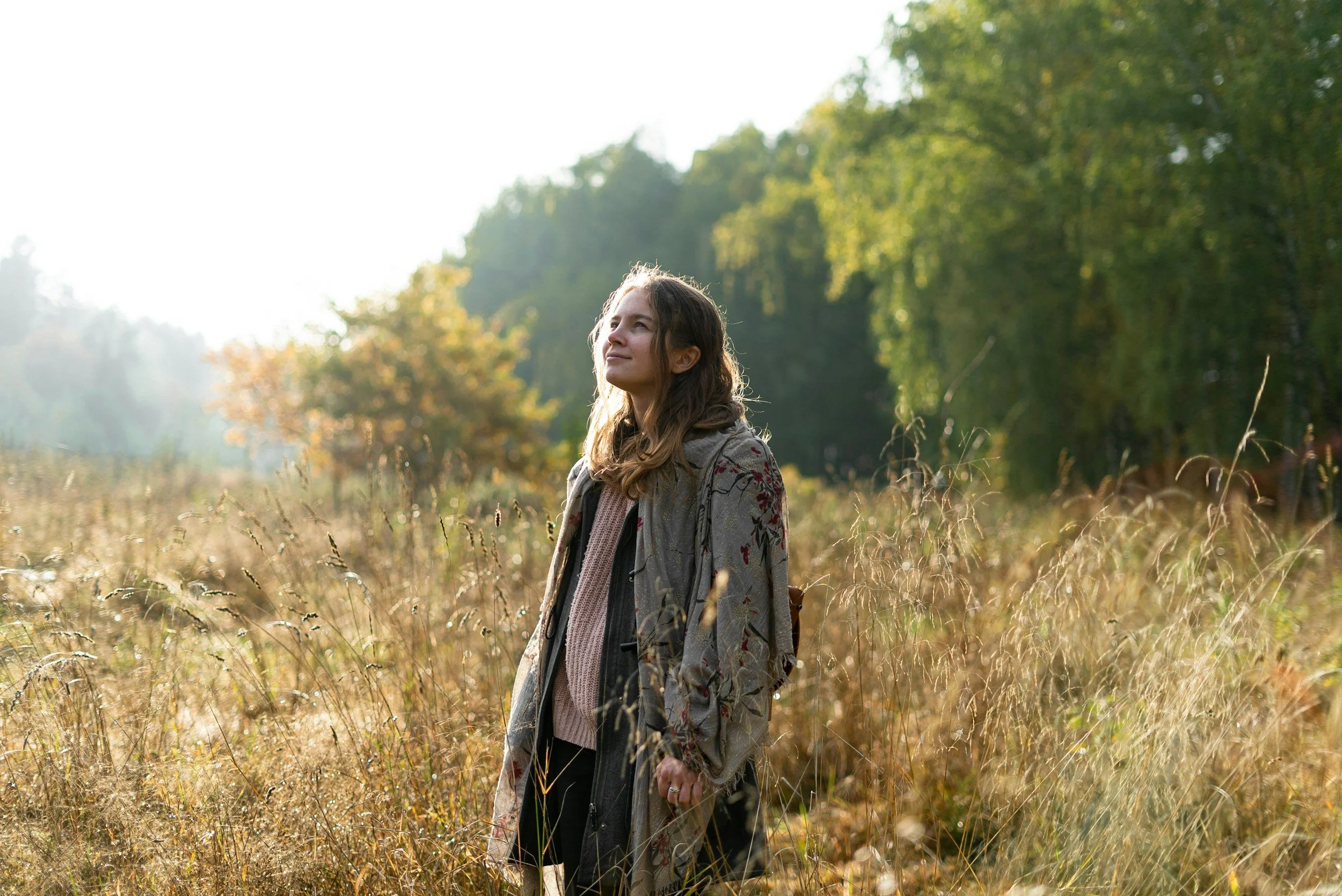 Woman standing outdoors reflecting during a life transition