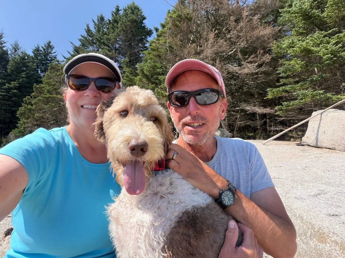 Karin and her husband with their dog, Finn, on the Maine coast