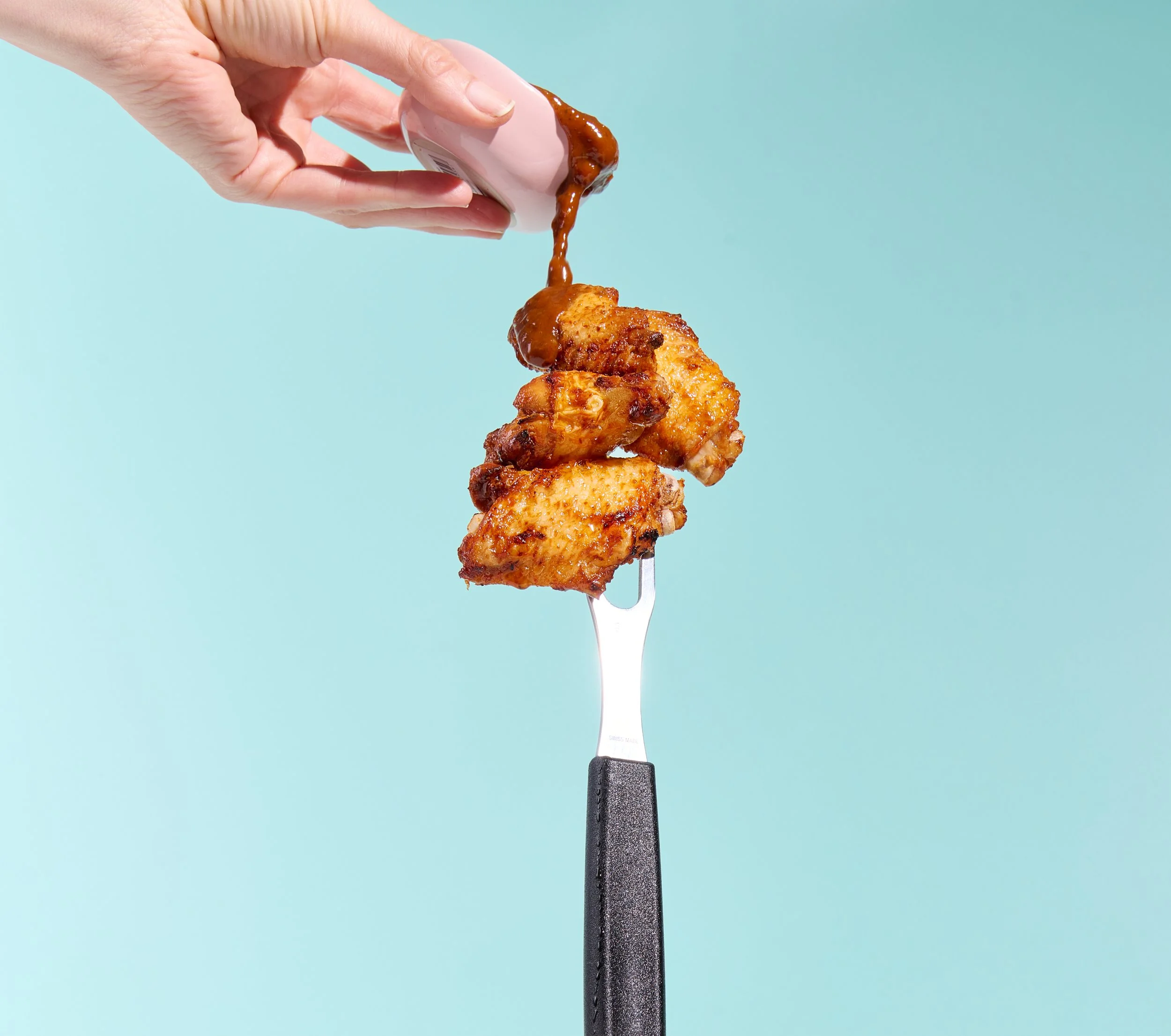 chicken wings in fork BBQ sauce.jpg