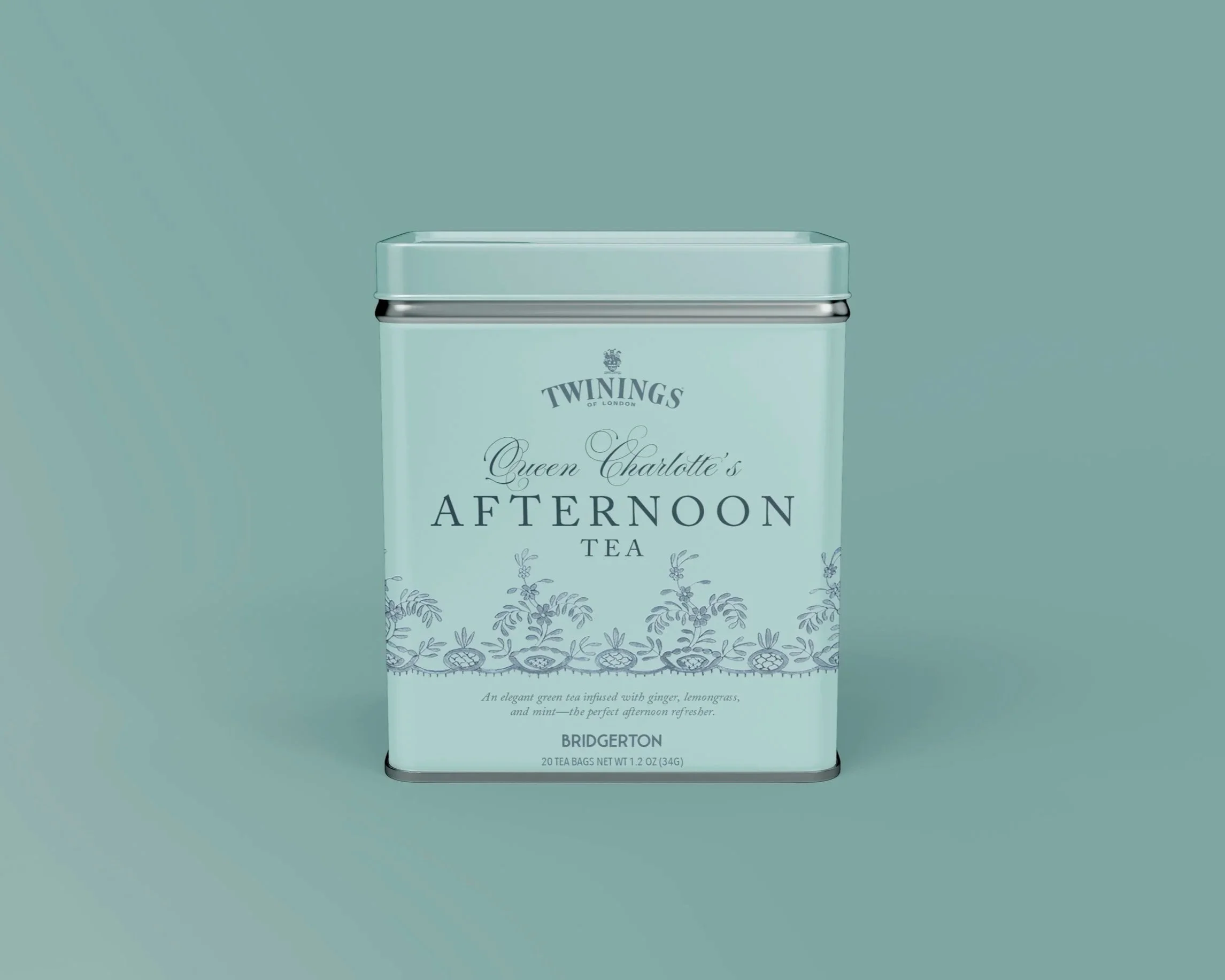 A teal-colored metal tin containing Twinings Queen Charlotte's Afternoon Tea bags, with elegant floral and leaf design on the packaging, set against a matching teal background.
