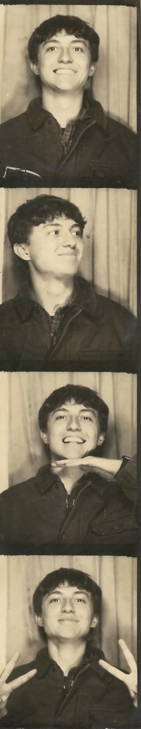 A young man with curly hair and a jacket, smiling in the first photo, looking to the left in the second, smiling with his hand under his chin in the third, and making peace signs in both hands in the fourth. The background is a curtain.