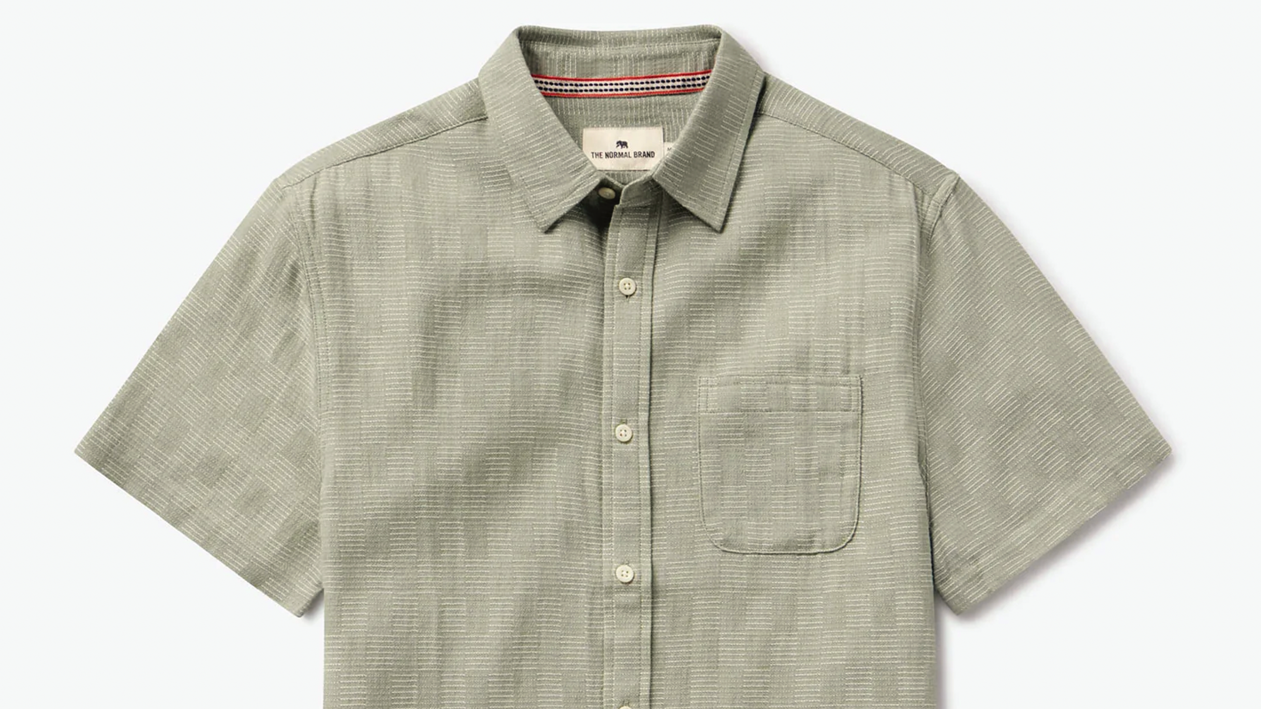 Light green short-sleeve button-up shirt with a subtle checkered pattern, a front pocket, and a pointed collar.