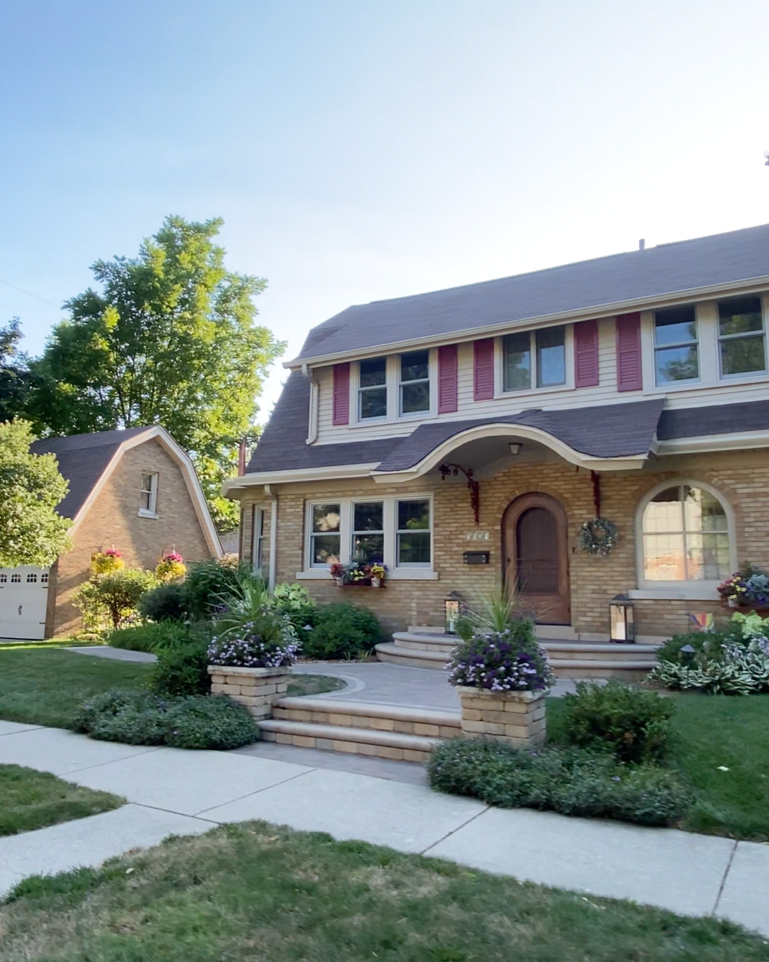 Cream brick Dutch Colonial home in a Milwaukee neighborhood