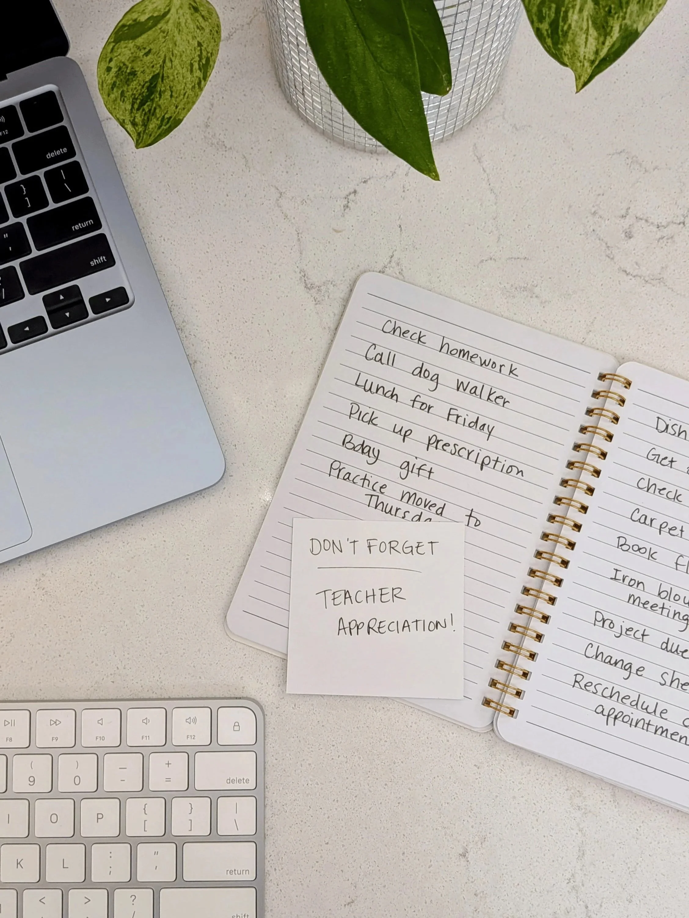 Household to-do list representing the mental load that Lighter Home household management service reduces for busy families in Gainesville, FL. The list is placed near a laptop, keyboard, and a plant with green and yellow leaves.