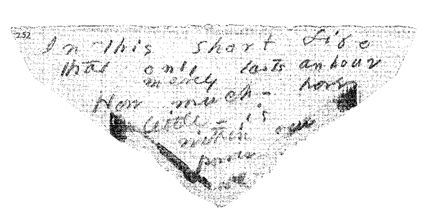 Close-up of an old, worn paper with faded handwritten cursive text, partially visible, on a dark background.