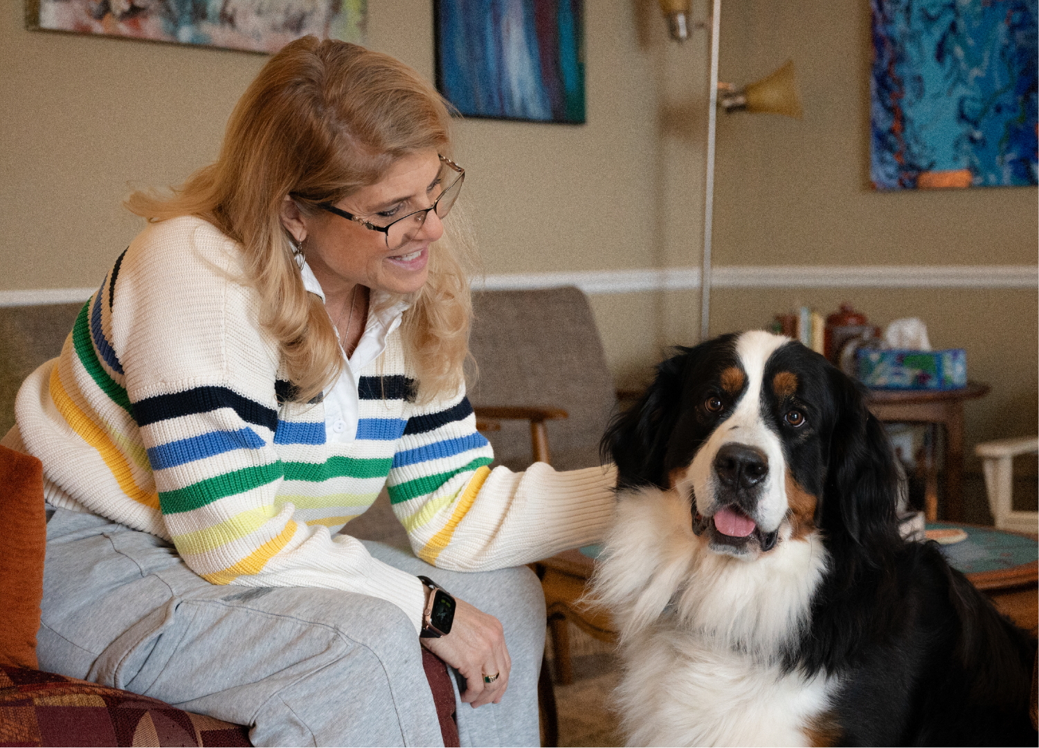 Picture of Sue with her new puppy in the office waiting room.
