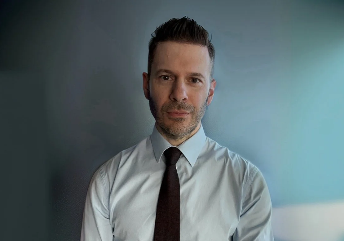 Steve Charalambous, relationship therapist, seated in a counselling setting