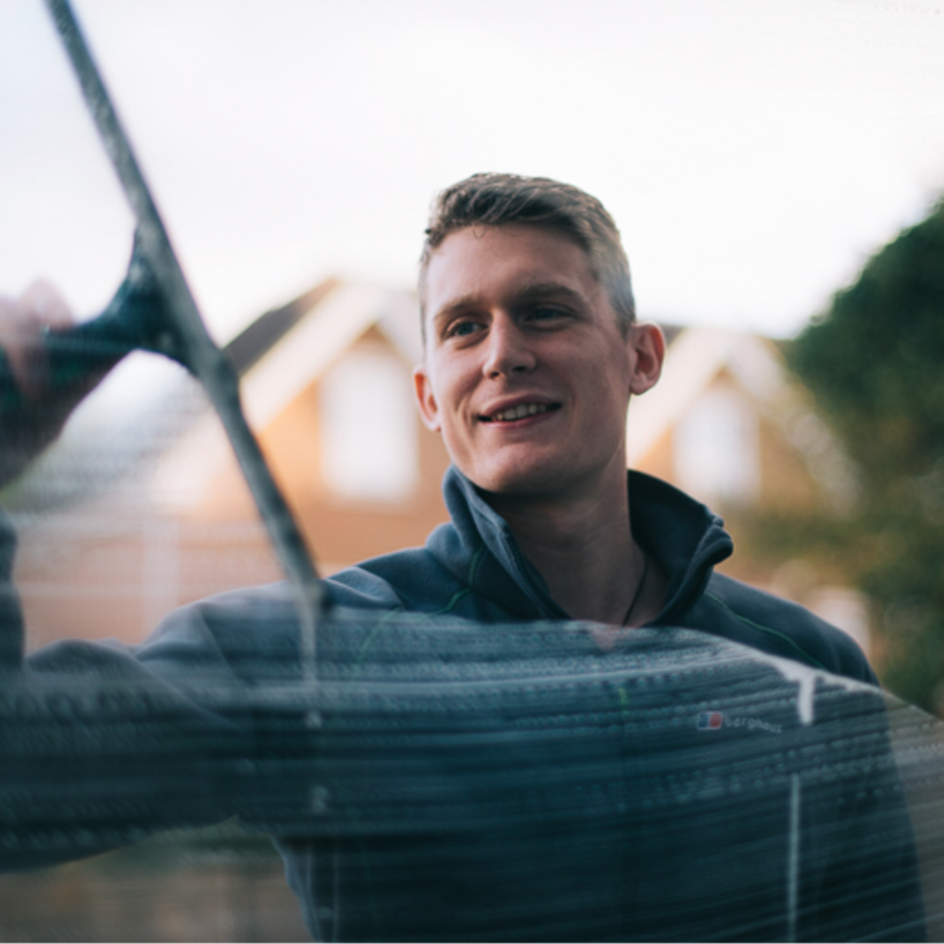 James using traditional window cleaning tools to Clean windows.