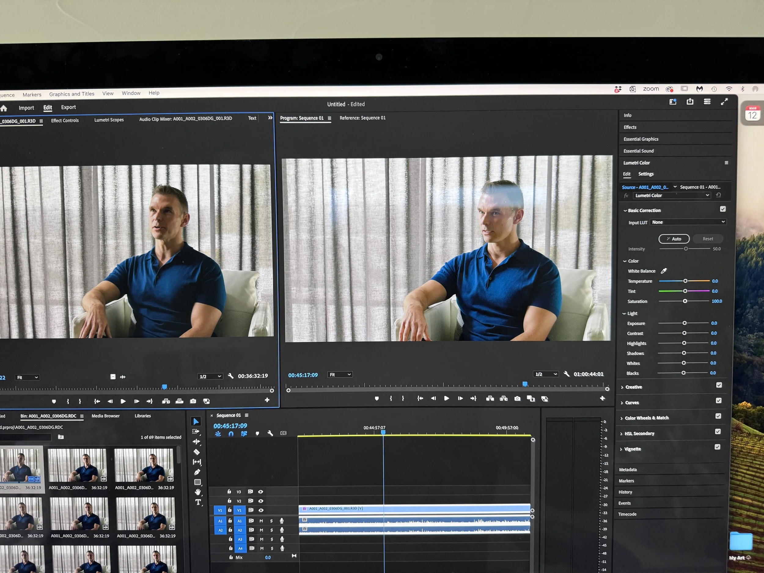 A computer monitor displaying a video editing software with two side-by-side clips of a man in a blue shirt sitting in front of curtains.