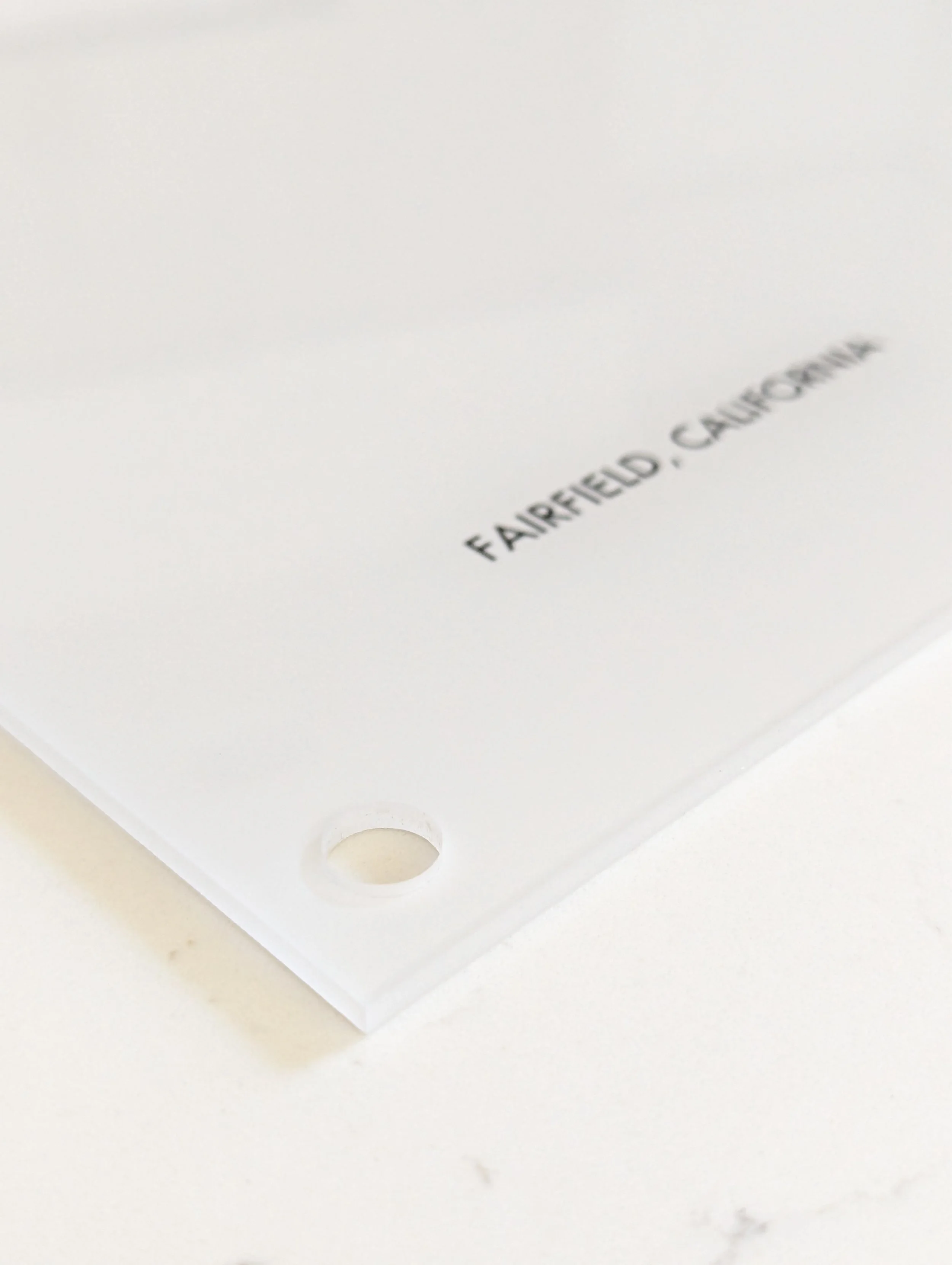 Close-up product photograph of Decision Height Industrial Acrylic print showcasing the high-gloss surface texture, deep subsurface print fusion, and a corner-mounted industrial aluminum standoff hardware fixture.