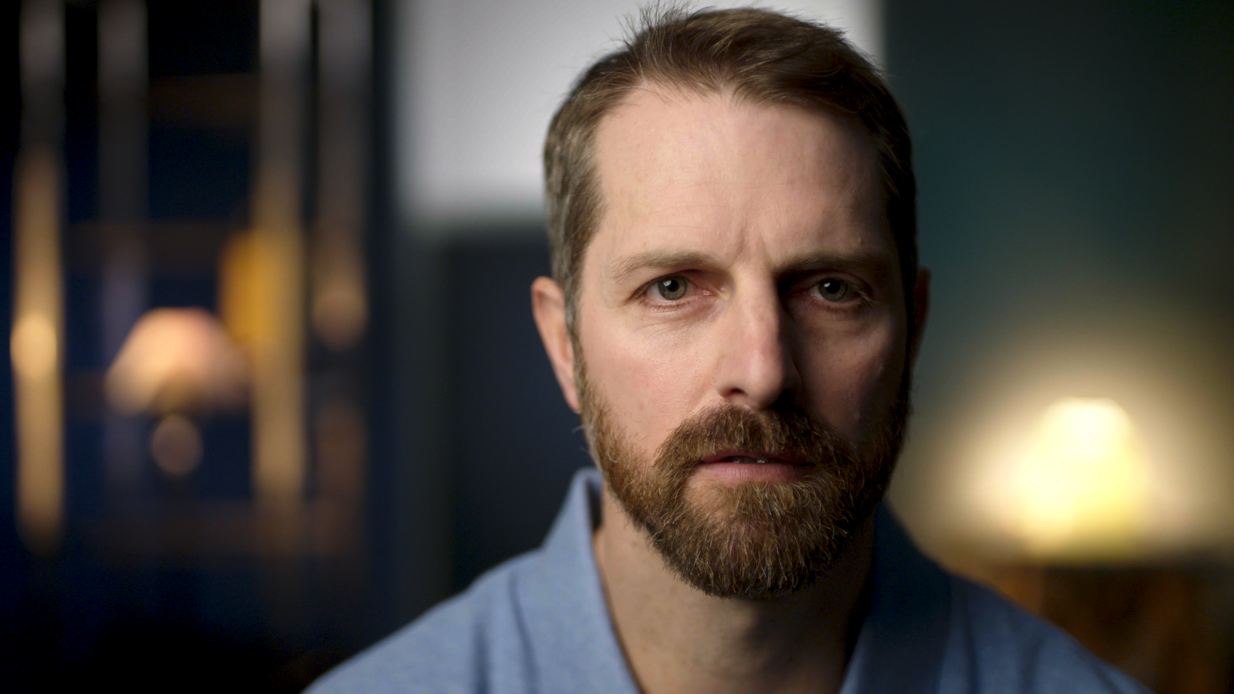 Documentary interview shot of a man looking at camera