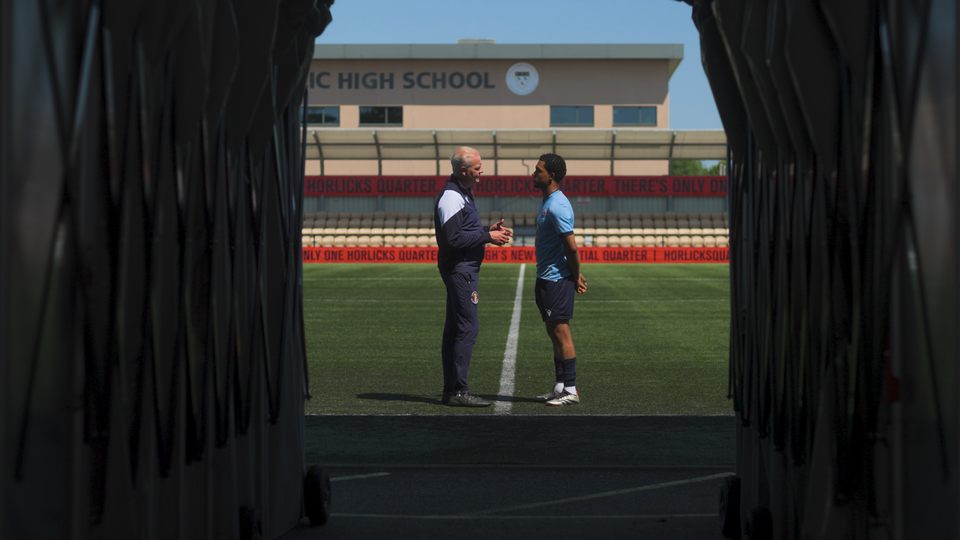 Two footballers facing one another at the end of the tunnel in a narrative drama video