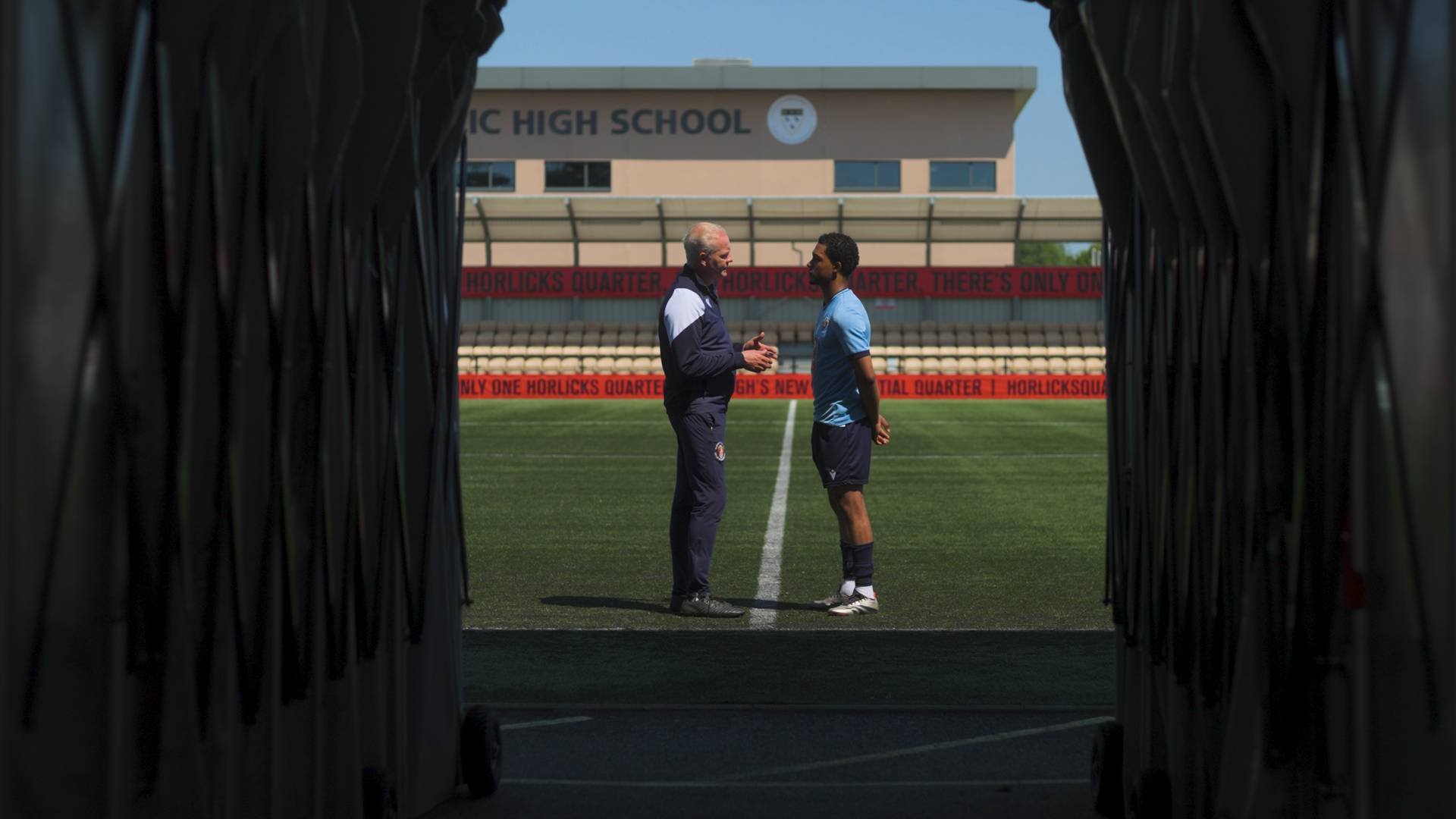 Two footballers facing one another at the end of the tunnel in a narrative drama video
