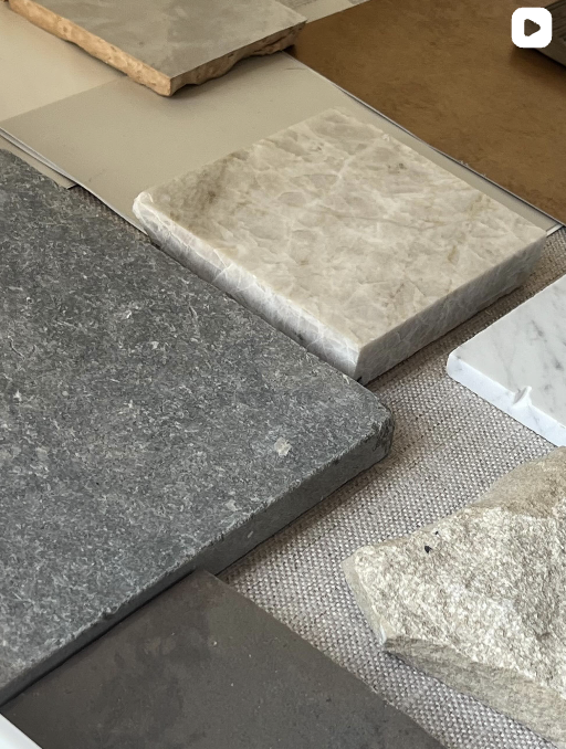 Various stone samples with different textures and colors displayed on a table.