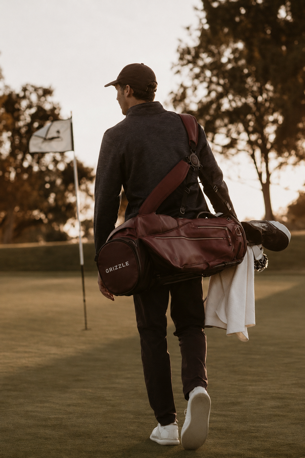 Golfer walking to the pin carrying a Grizzle golf bag