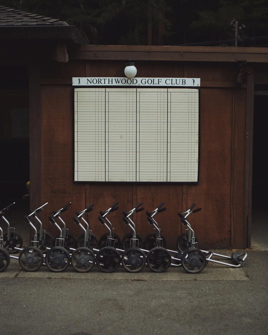 Push carts lined outside Northwood Golf Club.