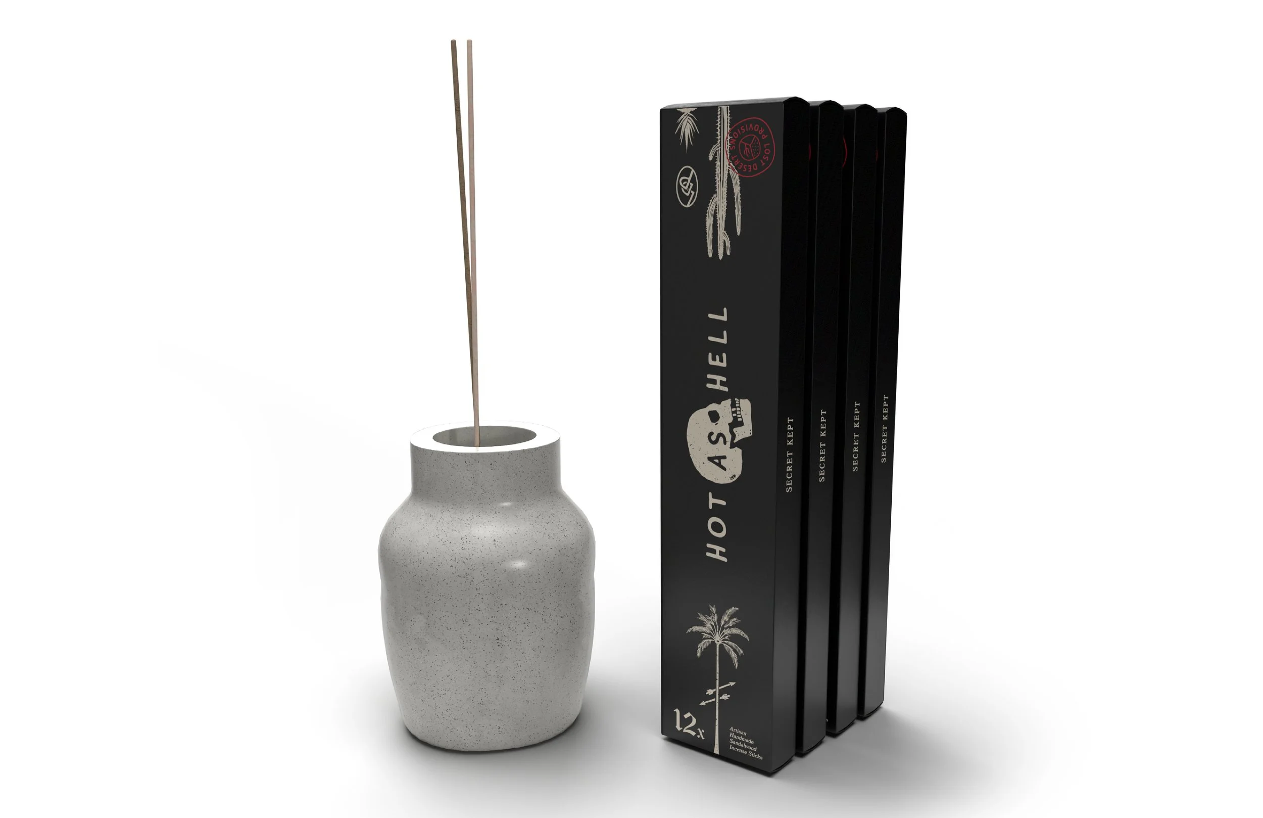 A white speckled ceramic vase with an incense stick standing upright inside it, beside a black box containing 12 incense sticks with tropical palm tree graphics and the text "HOT AS HELL".