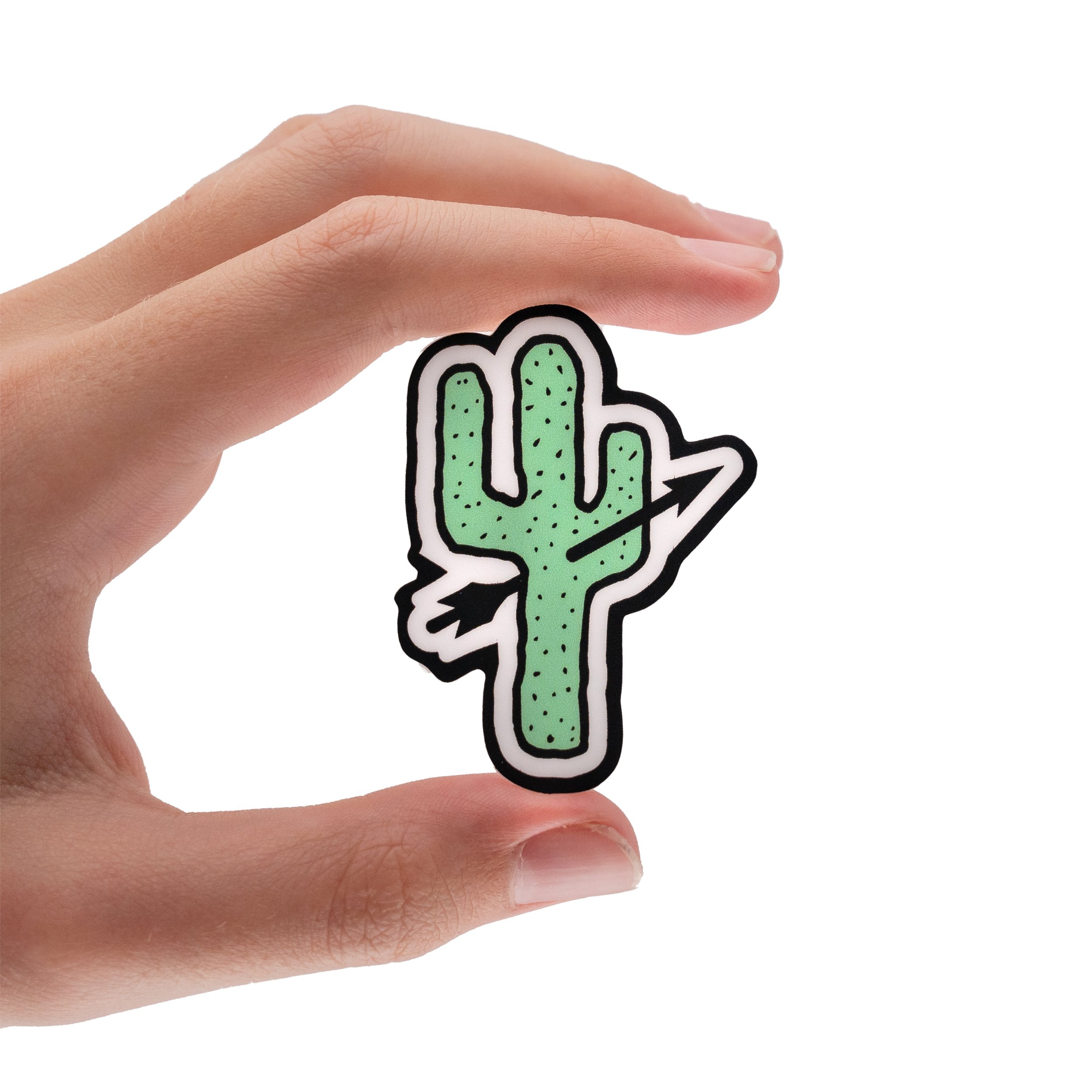 Close-up of a hand holding a sticker of a green cactus with a white outline on a white background.
