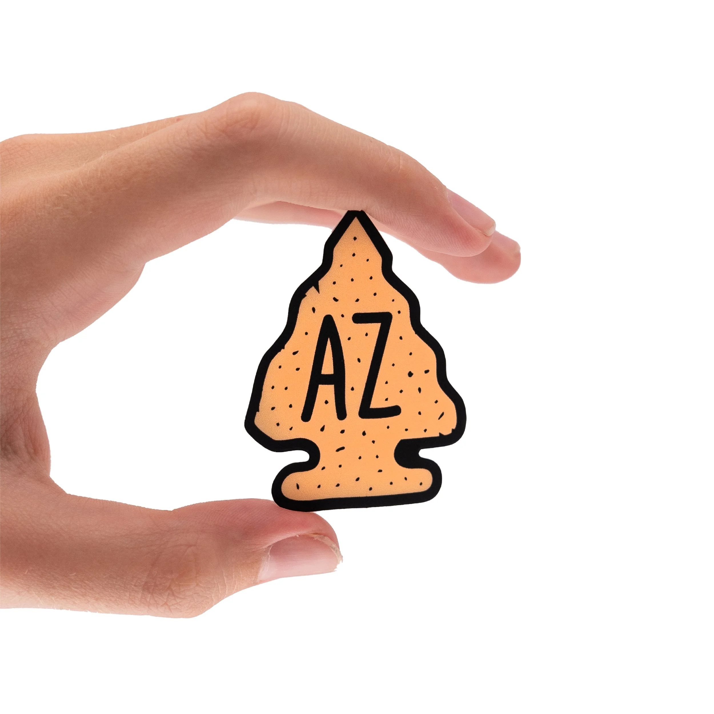 Close-up of a hand holding an arrowhead sticker with the letters 'A' and 'Z' on it against a white background.