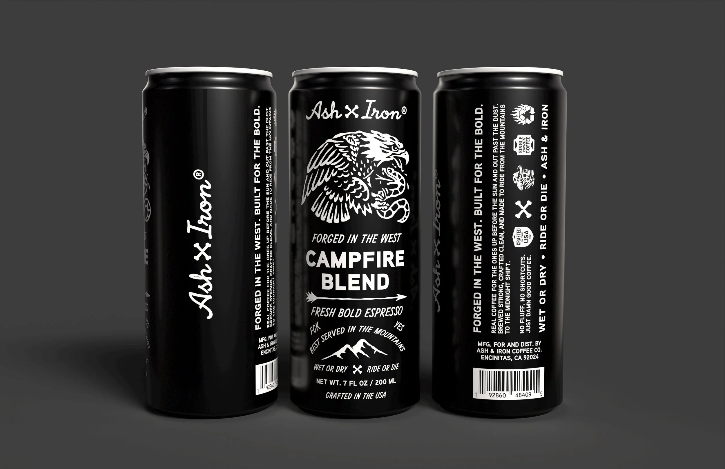 Three black cans of Ash & Iron Campfire Blend coffee with white text and mountain graphic, standing amidst a dark background.