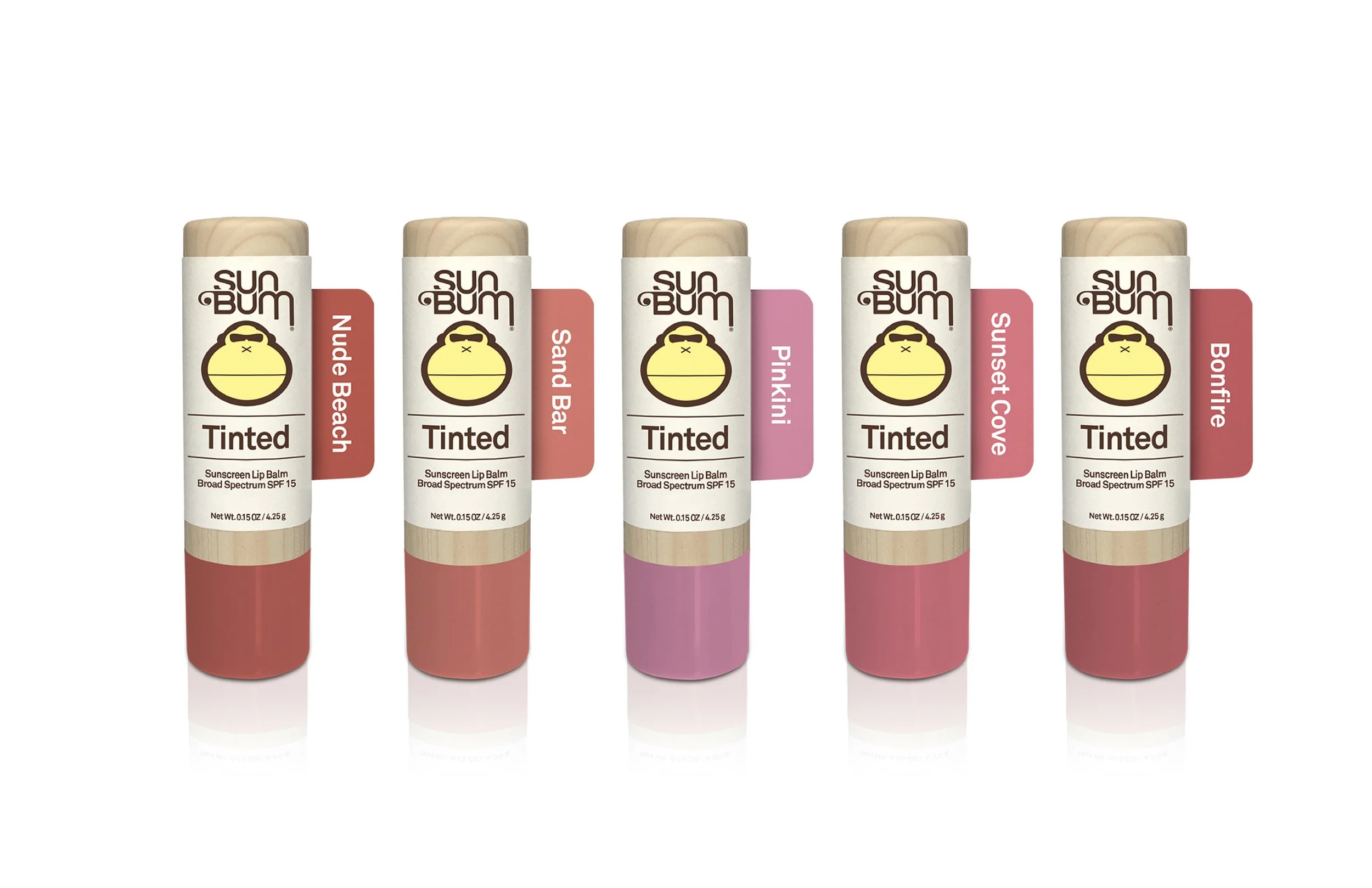 A lineup of five tinted lip balm tubes in different shades, labeled with names: Nude Beach, Sand, Pinkini, Sunset Cove, and Bonfire.