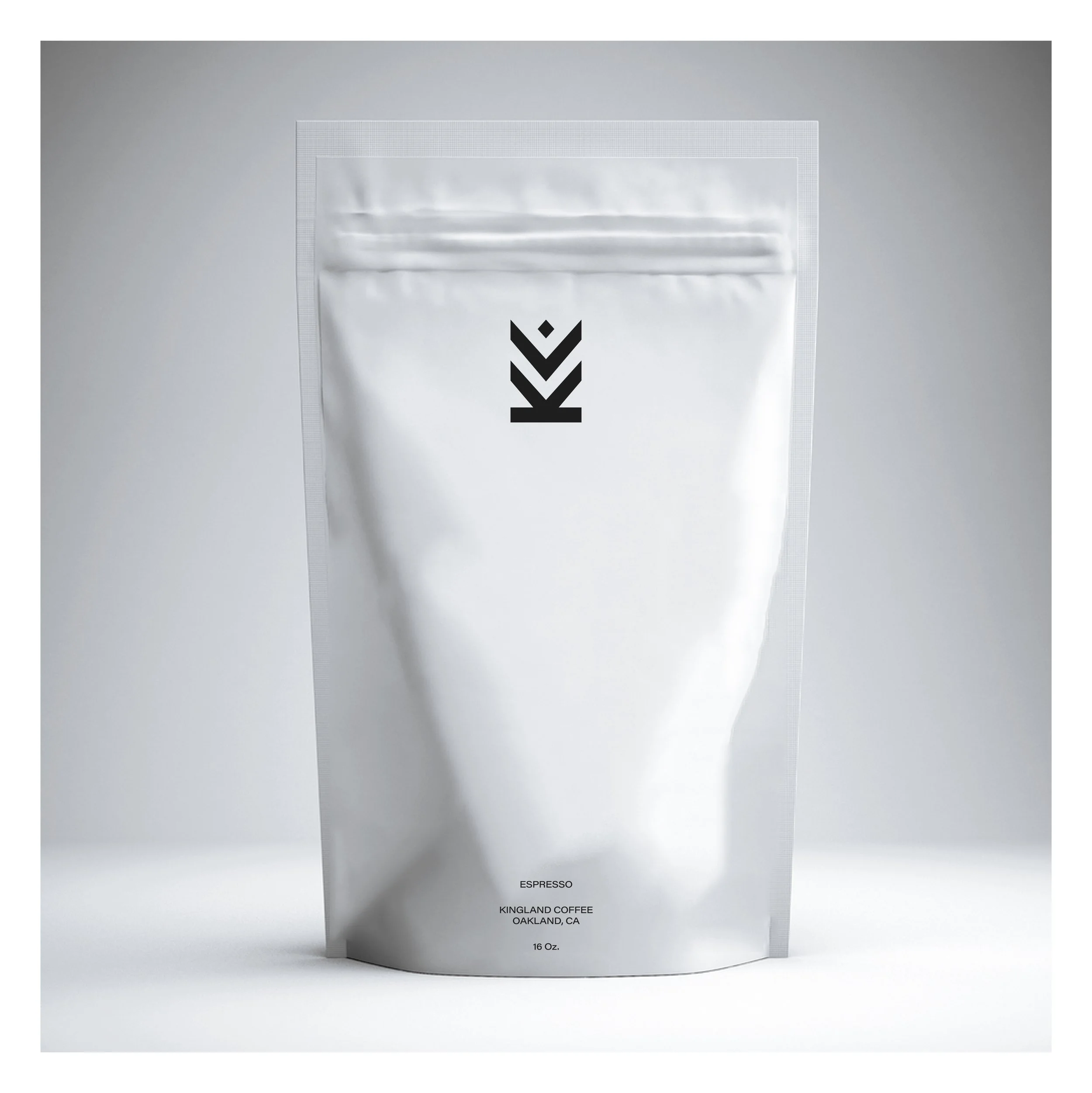 A white, resealable coffee bag labeled 'Espresso Kingland Coffee Oakland, CA 16 oz' with minimalistic black graphics.