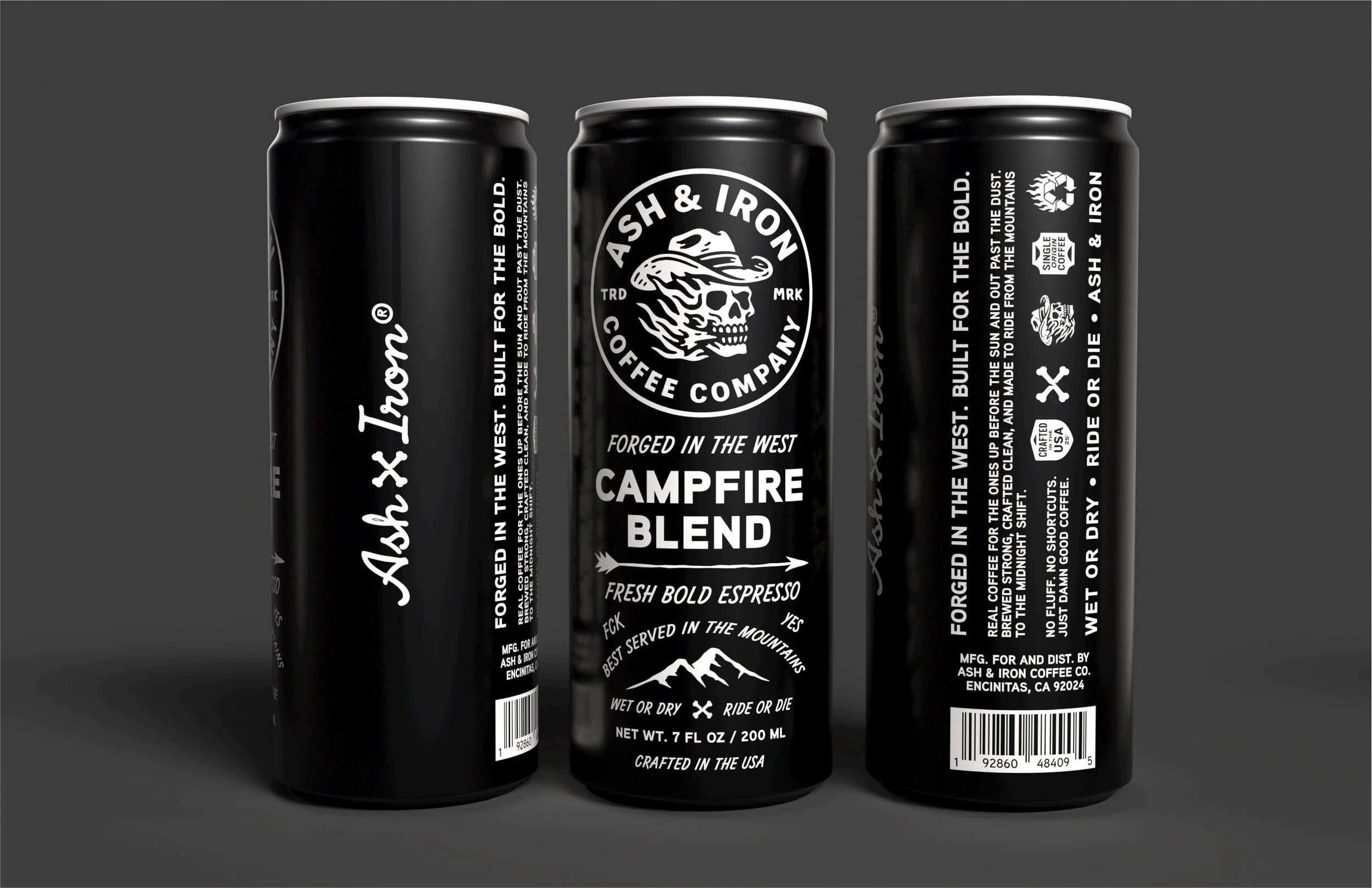 Three black cans of Ash & Iron coffee, featuring a skull with a mountain and the text 'Ash & Iron Coffee Company' and 'Campfire Blend'.