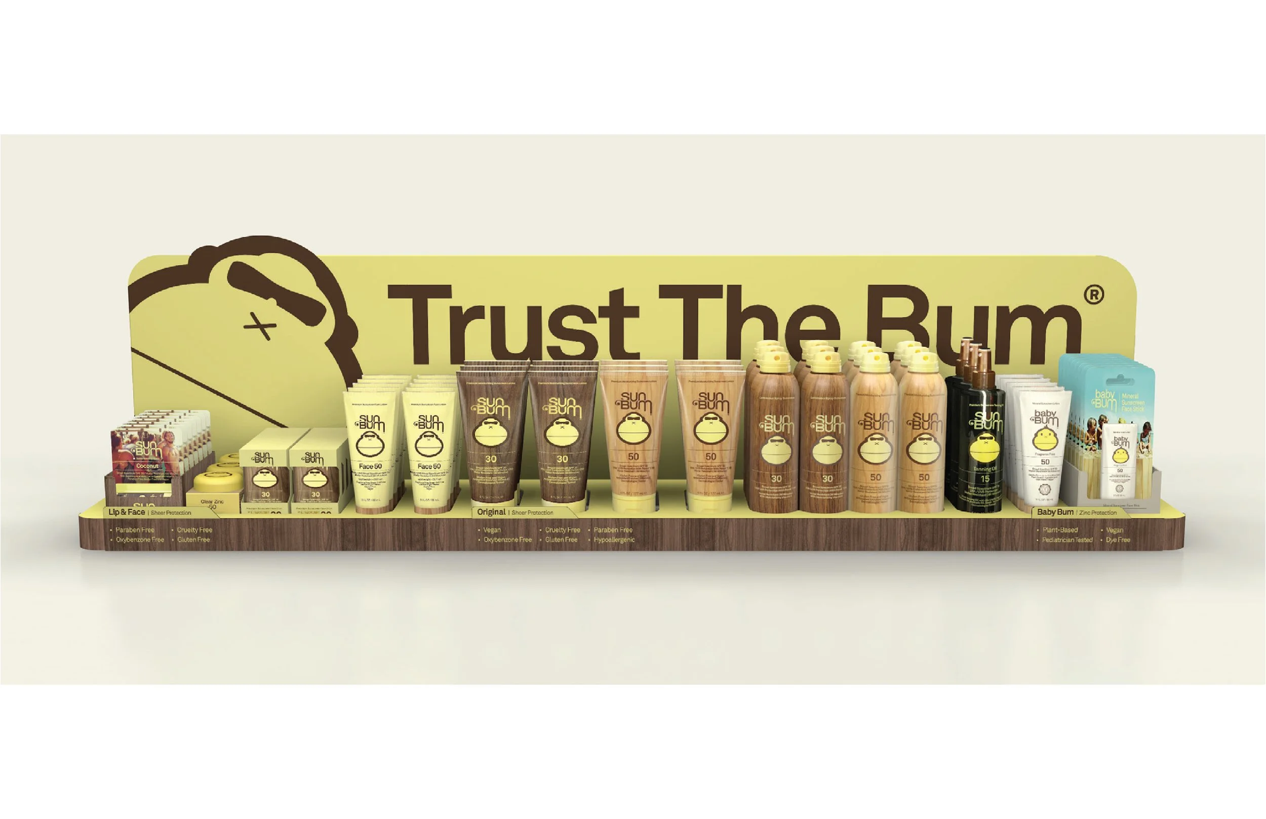 Display of Sun Bum skincare products including sunscreen lotions and sprays on a shelf with a yellow sign that says 'Trust The Bum'