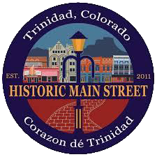 Seal of Trinidad, Colorado, featuring buildings, a streetlamp, and a brick sidewalk, with text indicating 'Trinidad, Colorado,' 'Est. 2011,' 'Historic Main Street,' and 'Corazon de Trinidad.'