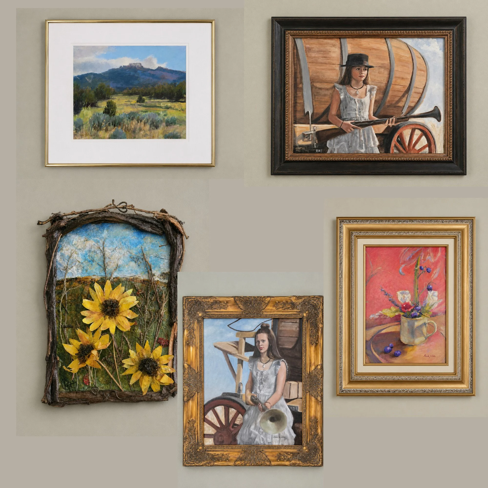 A gallery wall displaying four paintings: a landscape of mountains and fields, a portrait of a woman with a gun and wheelbarrow inside a large ornate frame, a bouquet of sunflowers in a rustic frame, and a painting of a bird and tree branches.