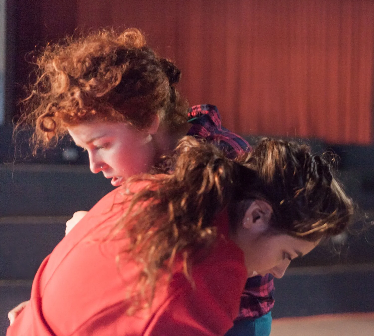 Anna and Leah dance together on the floor at Motorco. They share weight.