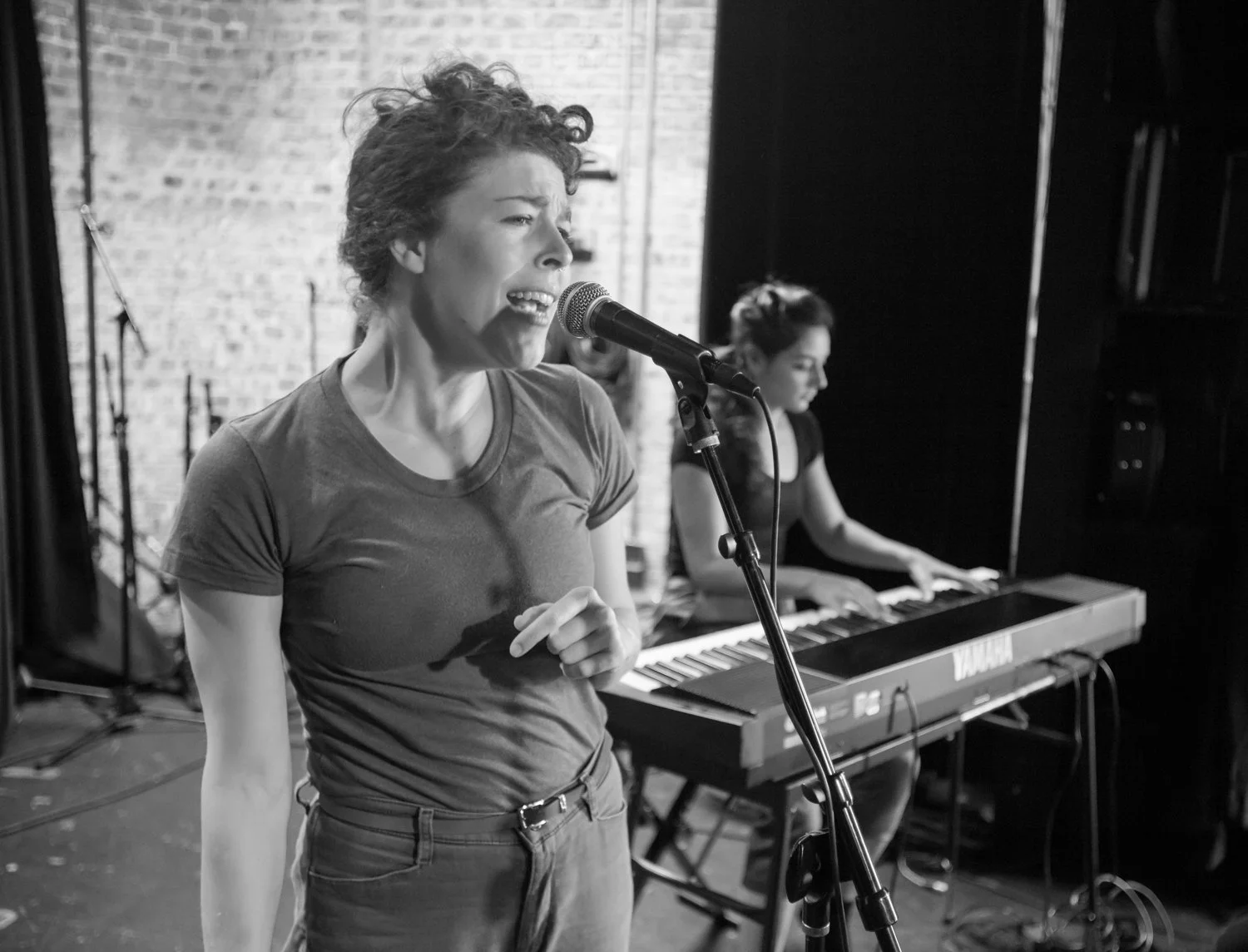 Leah sings while Anna plays a keyboard piano at Motorco.