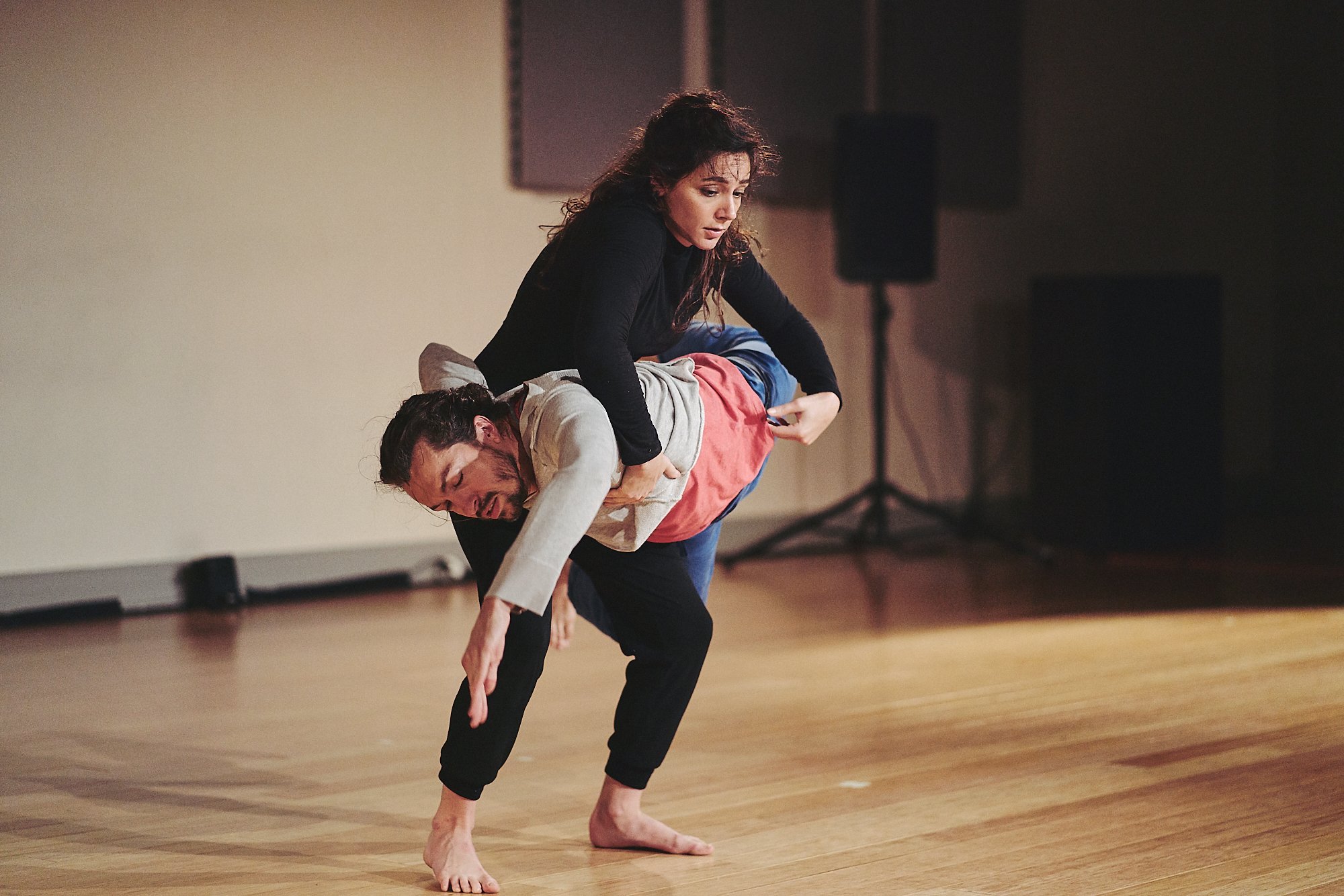 Anna lifts Christopher, who rolls up her body horizontally. 