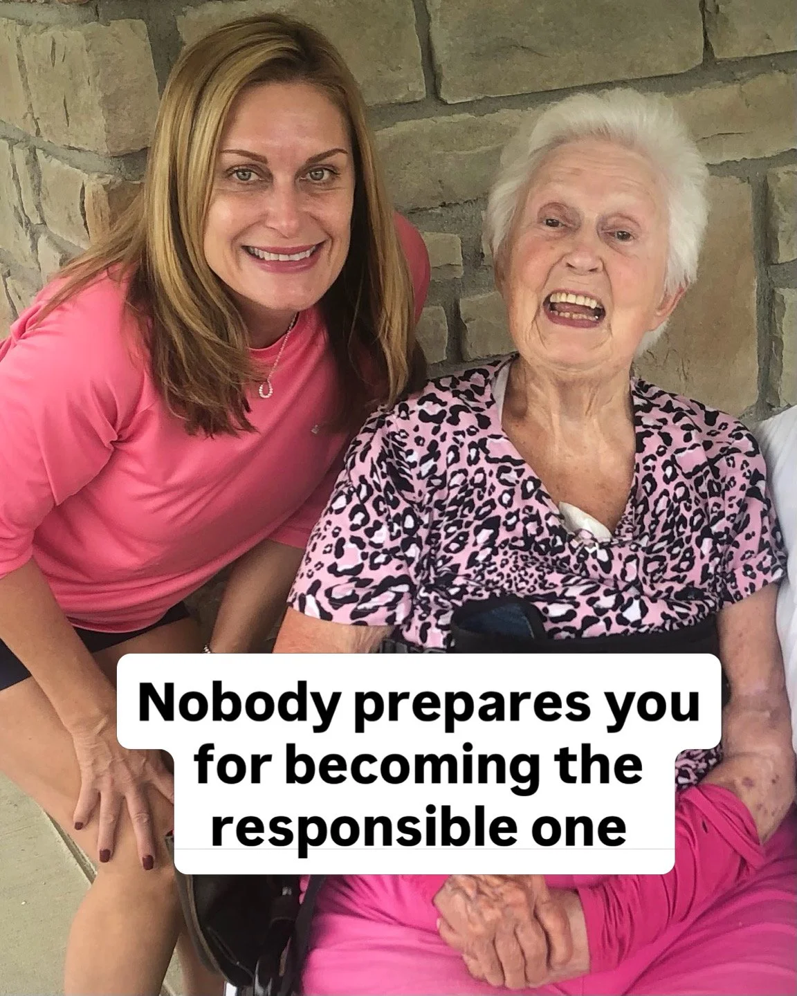 A young woman with long blonde hair smiling and a senior woman with white hair laughing, sitting next to each other against a stone wall. The senior woman is in a wheelchair wearing a pink and black leopard print shirt. The young woman is wearing a pink shirt. The photo includes a caption that reads: 'Nobody prepares you for becoming the responsible one.'