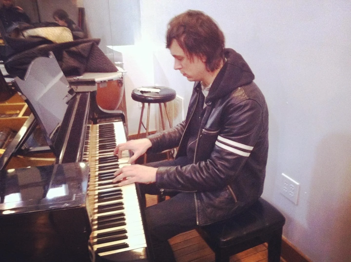 man playing piano in a music studio
