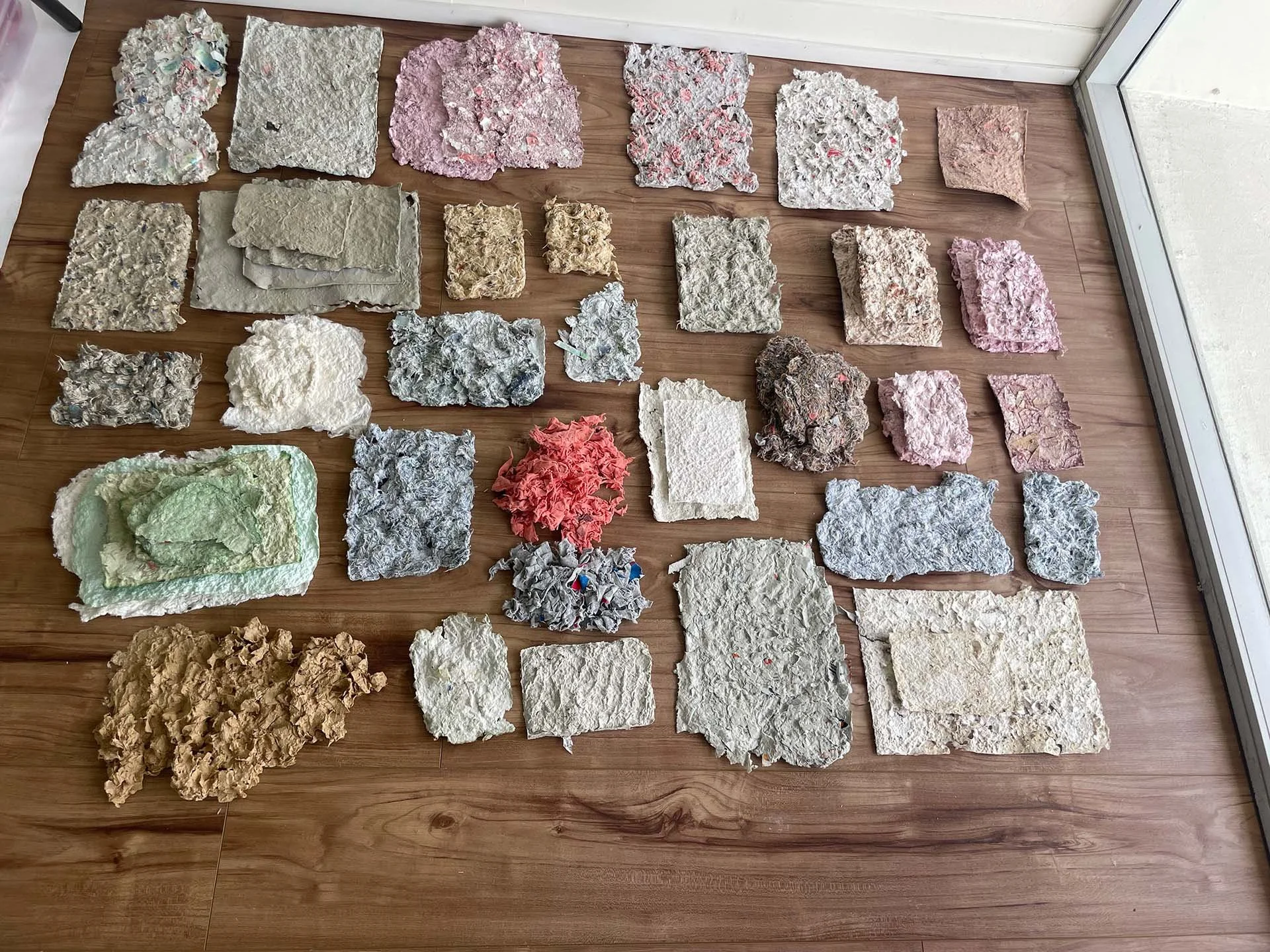Stacks of handmade paper, 2022, recycled packaging, clothing fibers, dimensions variable
