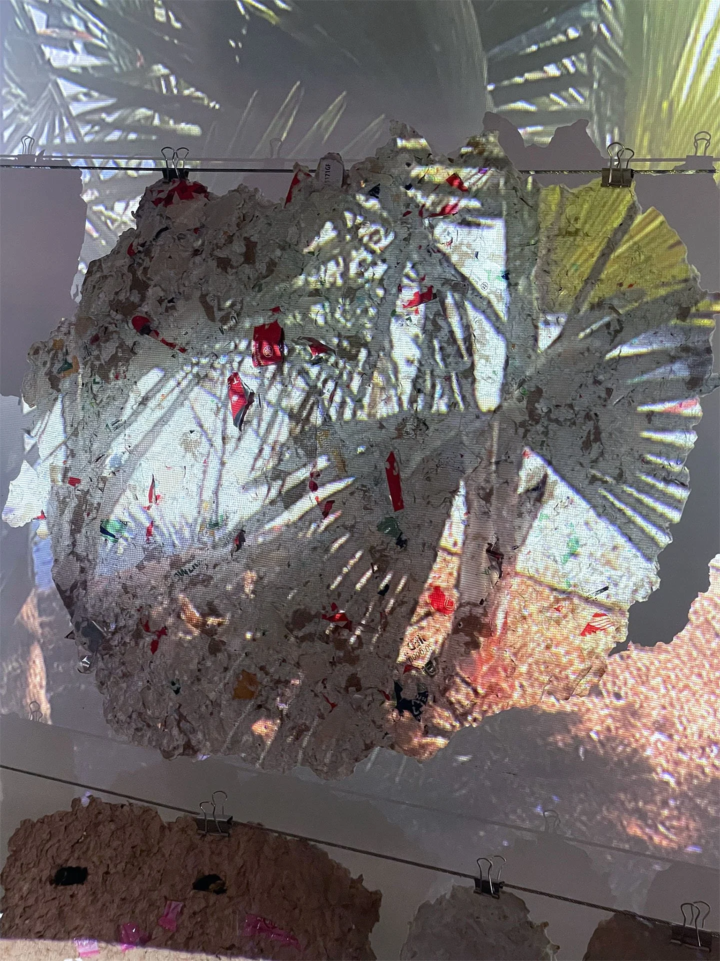 Fleeting Beauty (detail), 2022-2026, Pulp from packaging, clothing fibers, flowers, projection, dimensions variable