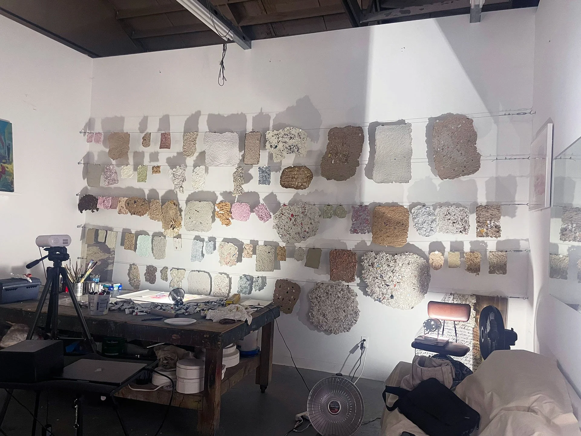 Fleeting Beauty studio installation, handmade paper, 2022, recycled packaging, clothing fibers, dimensions variable