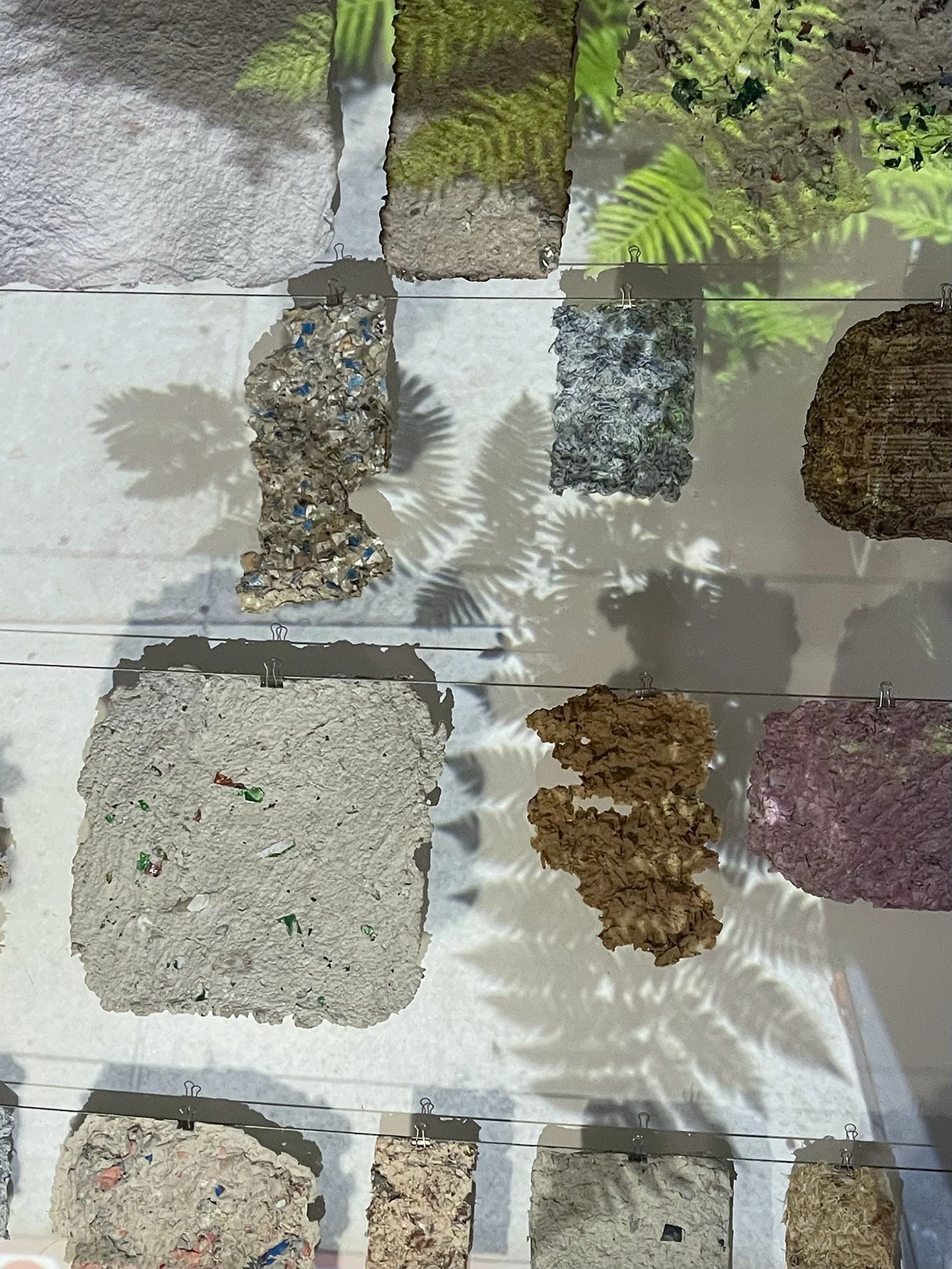 Fleeting Beauty (detail), 2022-2026, Pulp from packaging, clothing fibers, flowers, projection, dimensions variable