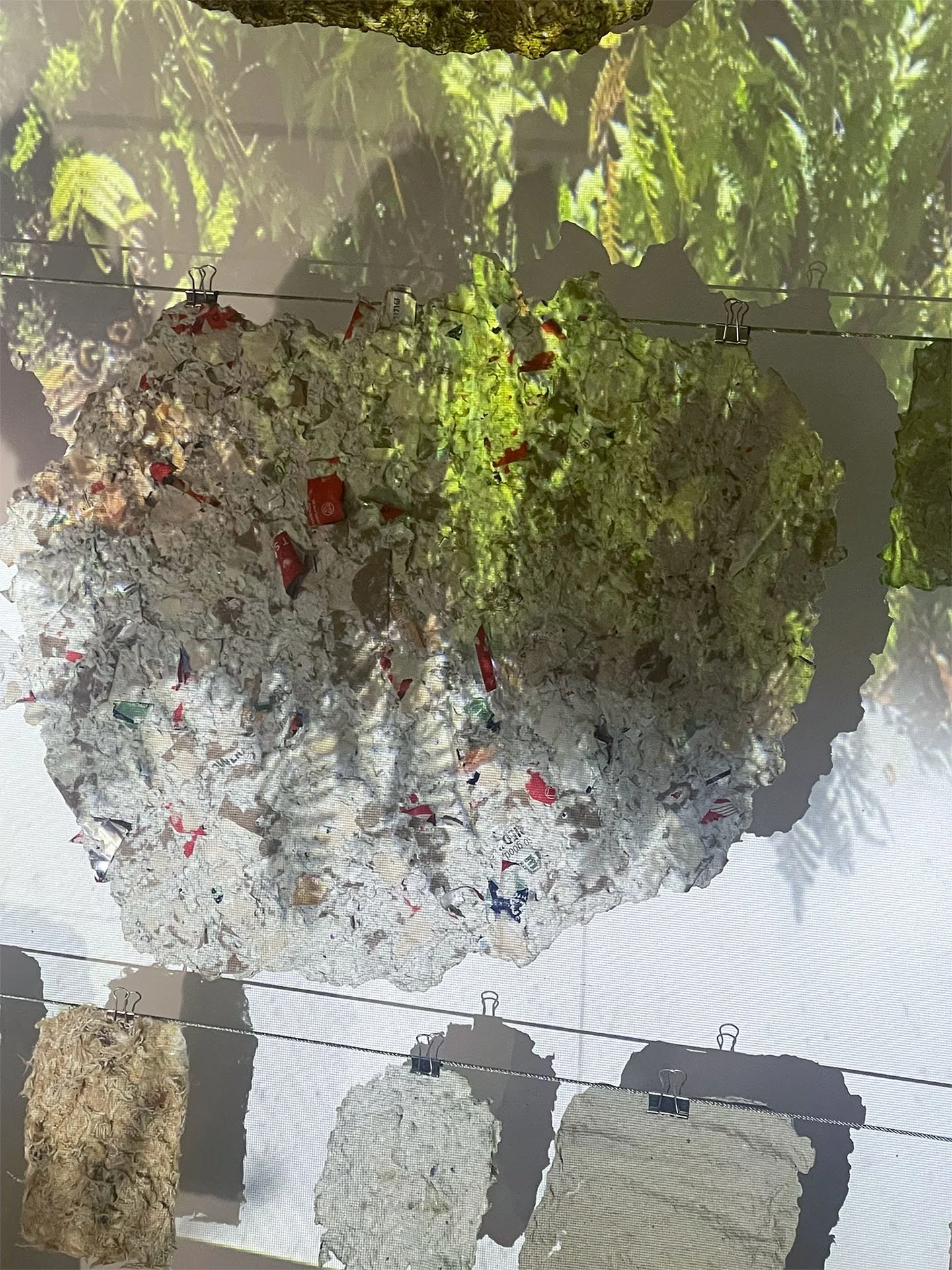 Fleeting Beauty (detail), 2022-2026, Pulp from packaging, clothing fibers, flowers, projection, dimensions variable