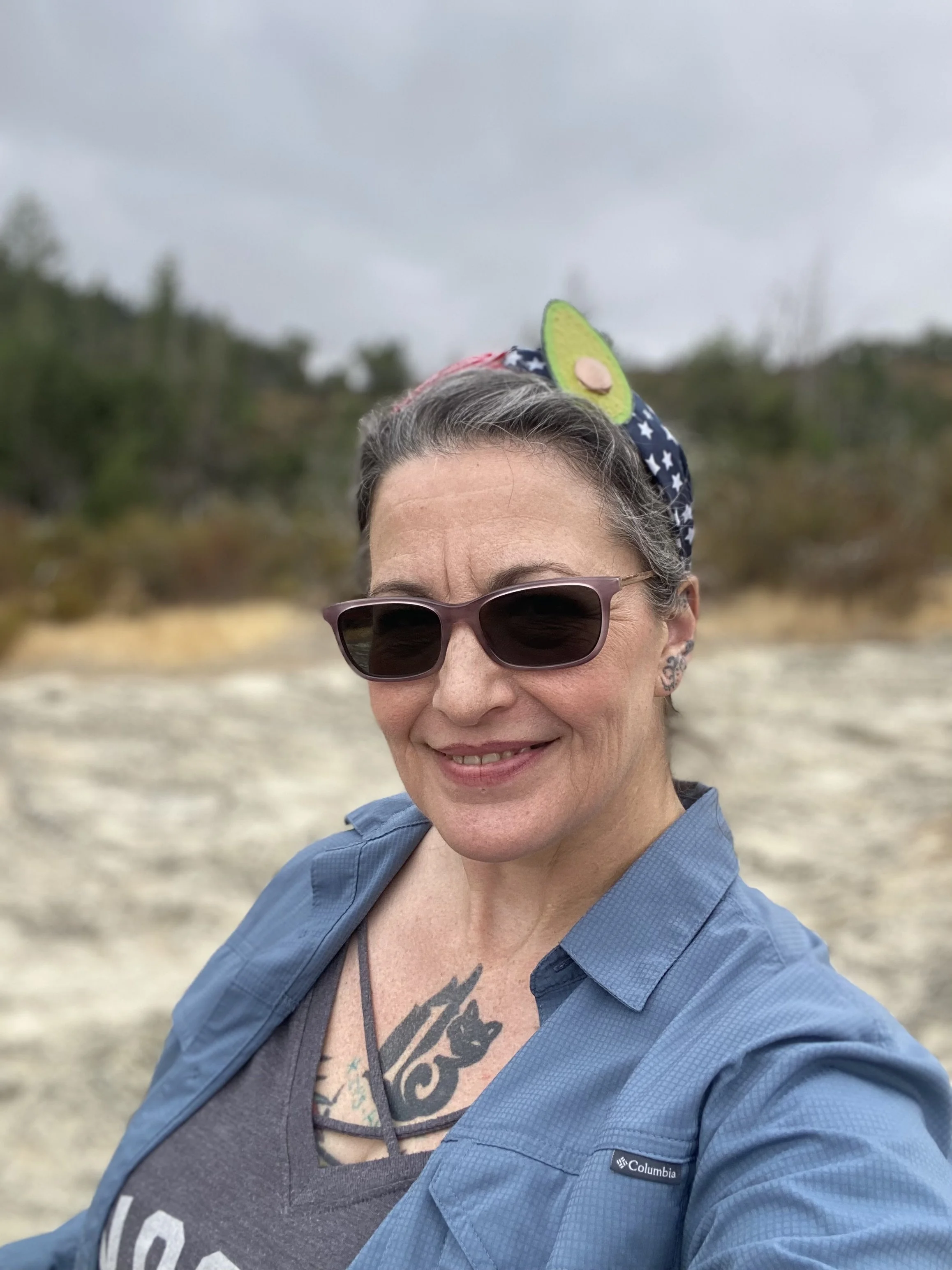 Violet smiling wearing sunglasses outdoors. Inspired by the calm, peaceful atmosphere of Violet's Harbor in Cotati, CA
