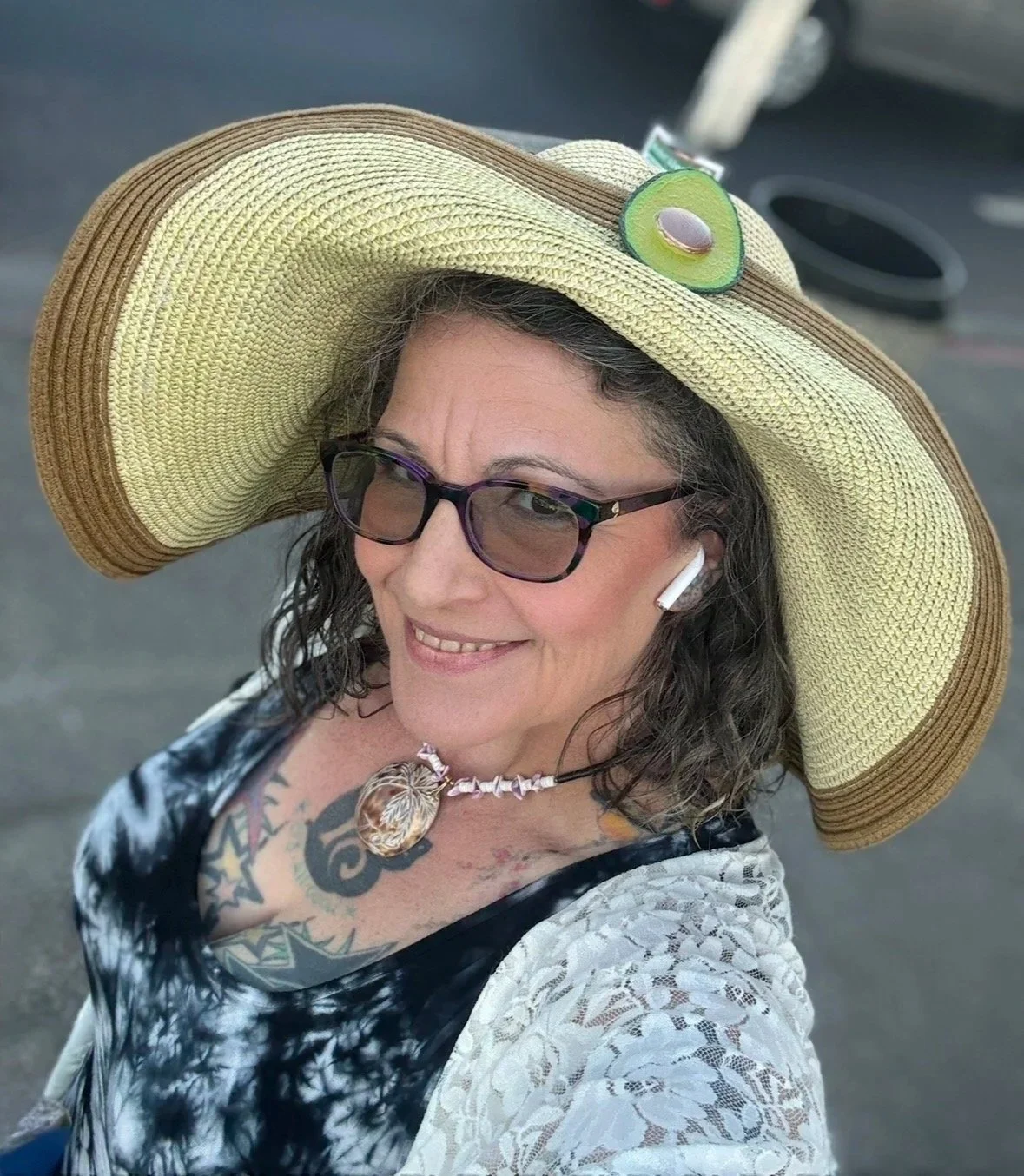 Violet smiling outdoors in a sun hat. Certified Massage Therapist serving Cotati, California