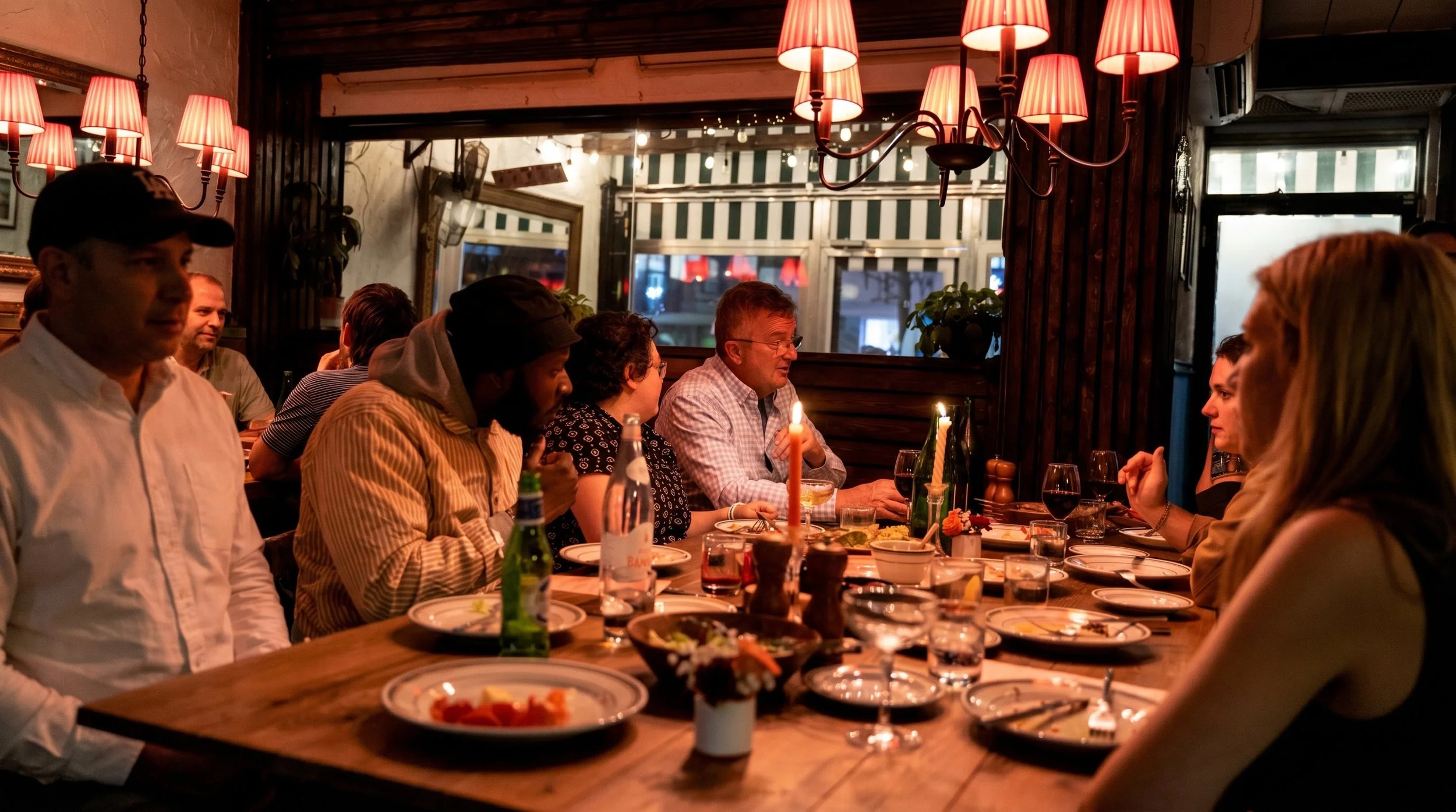 Guests gather around the table to enjoy communal dining and custom cocktails 