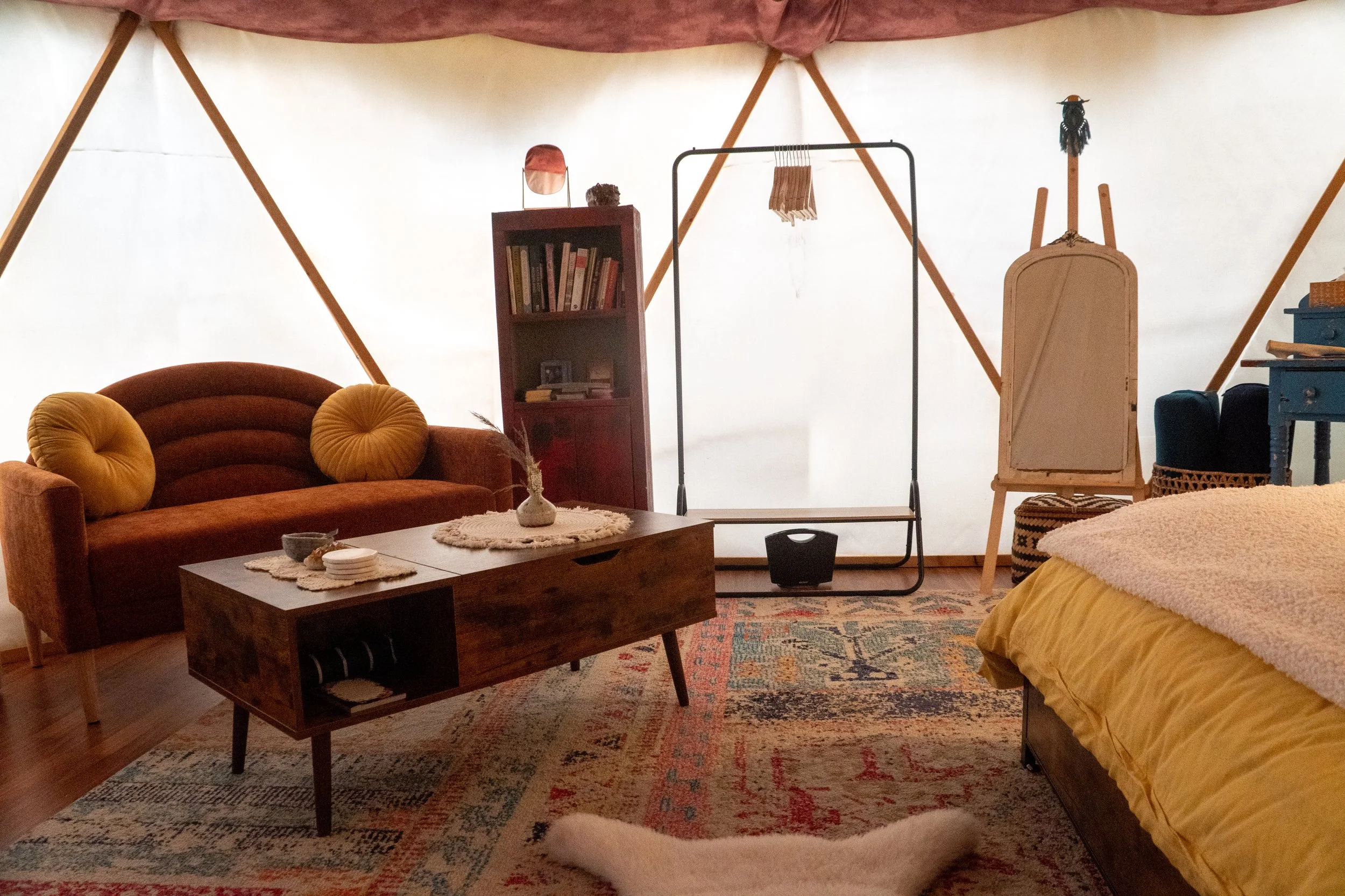 Cozy glamping yurt interior with queen bed and warm lighting