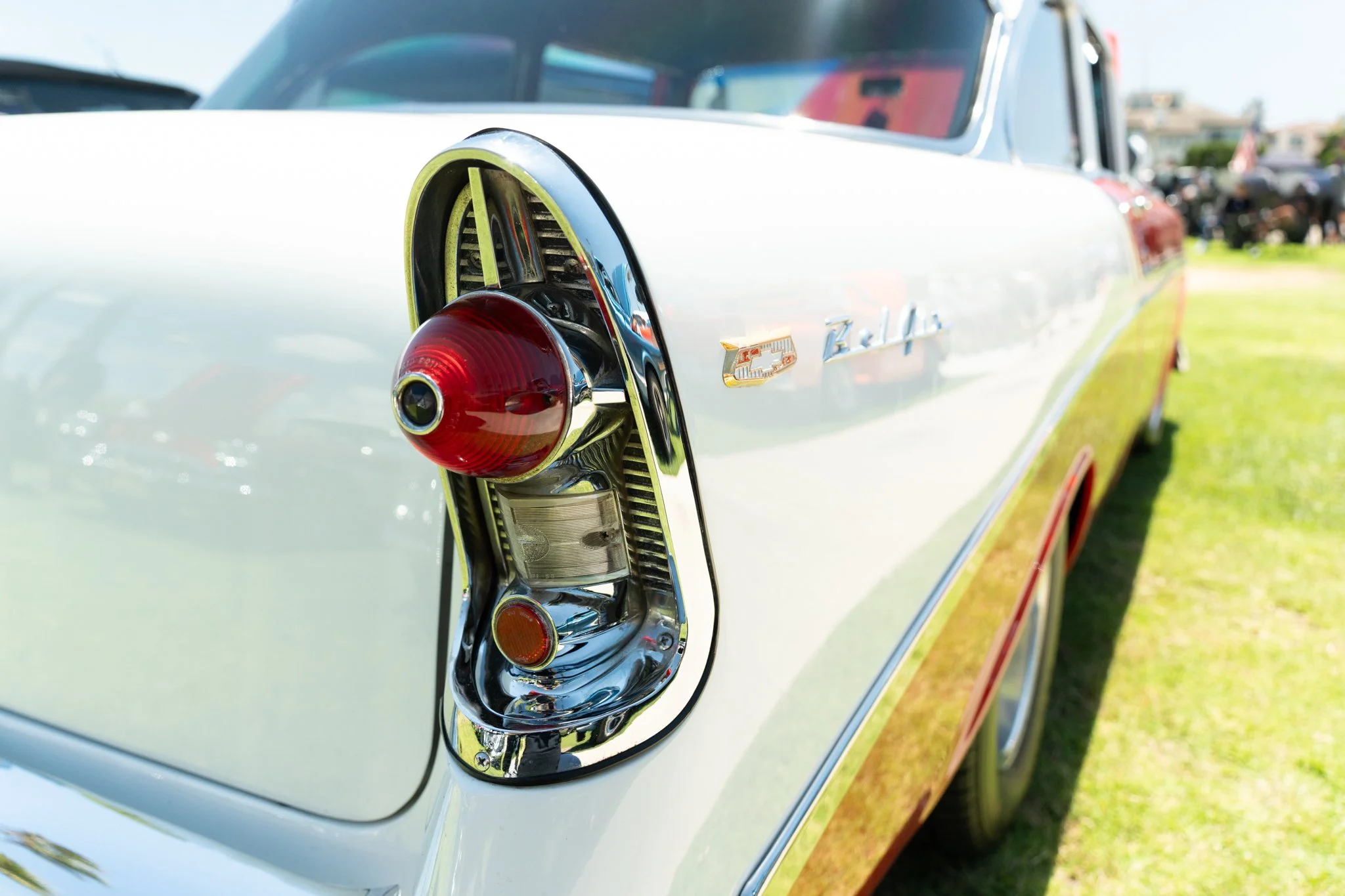 Close-up of the rear tail light and emblem of a vintage Chevrolet Bel Air car.