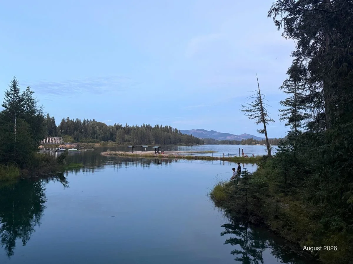 Albeni campground bridge and bay: Fishermen fish off the banks in the campground inlet at dusk. 