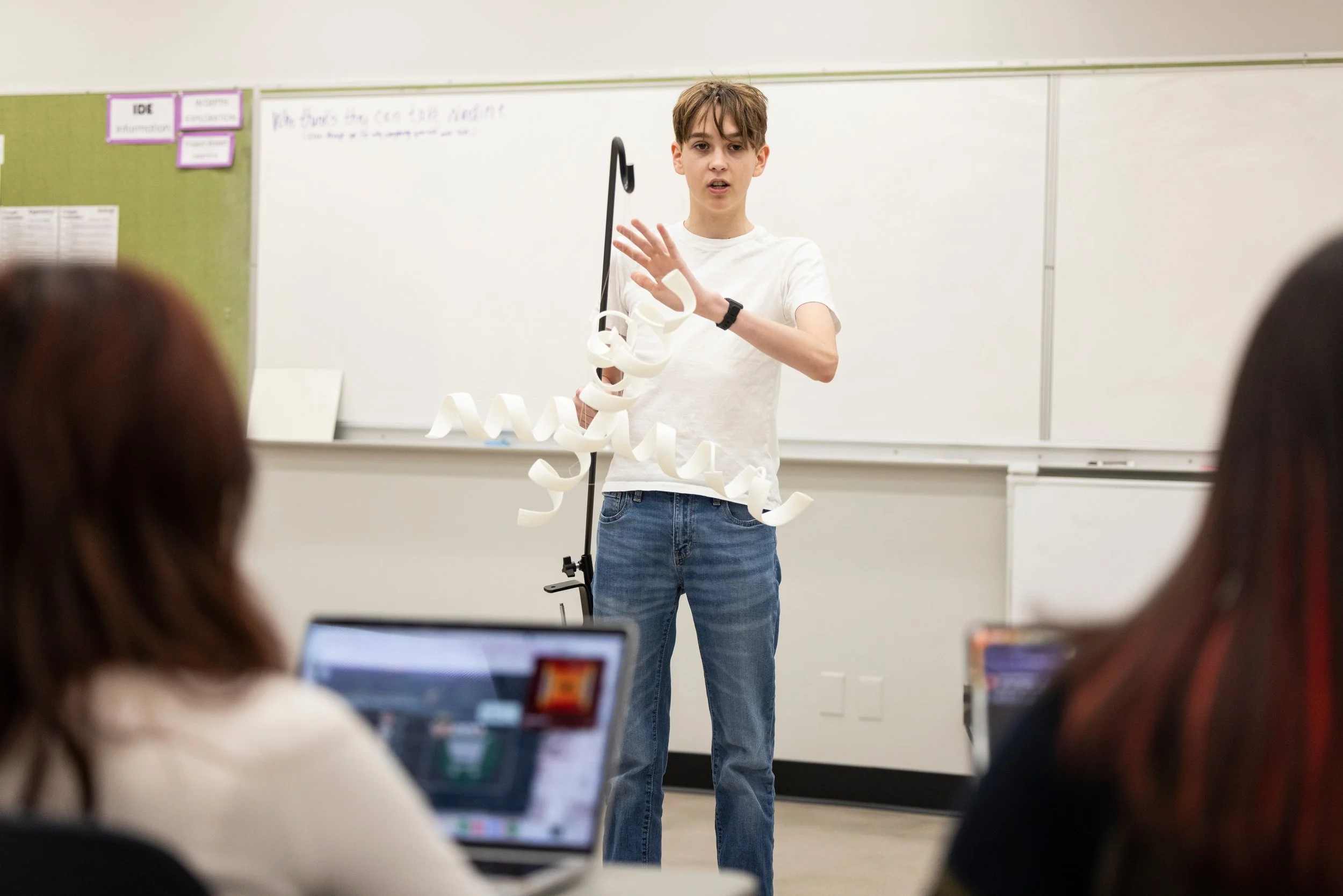 Student presenting a project at the whiteboard