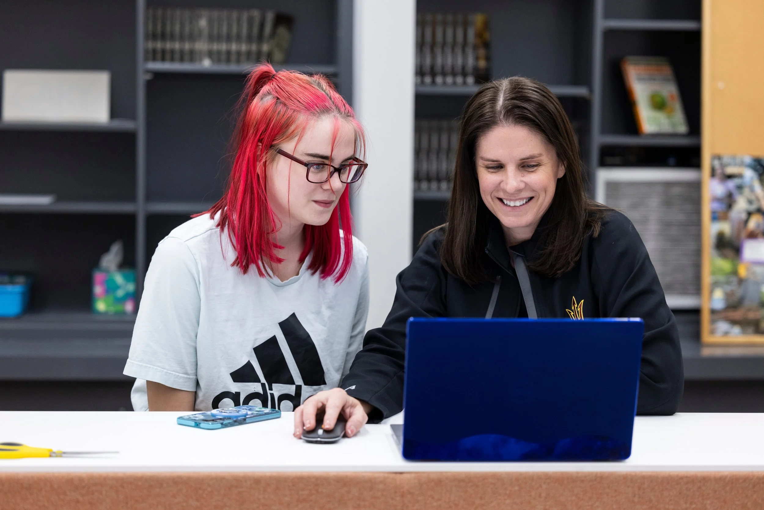Student getting one-on-one tutoring help on a laptop