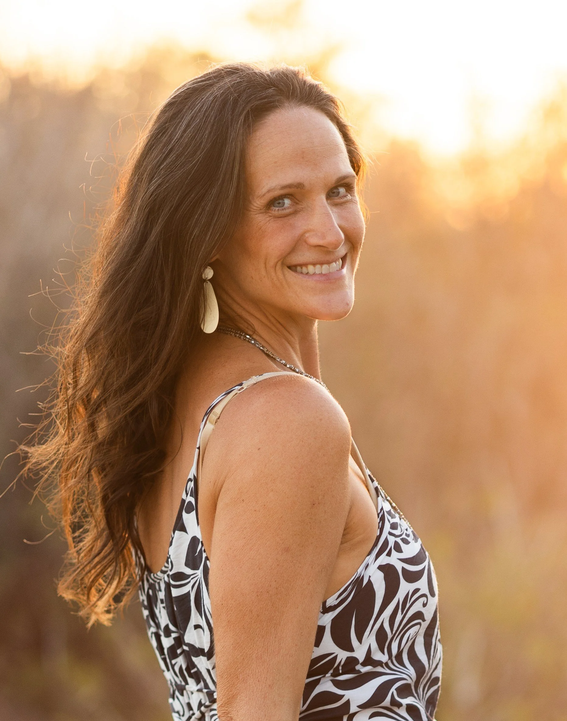 Beautiful Kauai evening sunlight hitting her hair with a natural glow, ease and peace on her face